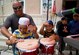 Technical Sgt. Richard Vasquez teaches local youth how to play percussion July 23, 2013, in Balykchi City central square, Kyrgyzstan. The AFCENT band invited locals of all ages to learn how to play instruments. The concert was part of the AFCENT band’s mission to build international partnerships. Vasquez is a  U.S. Air Forces Central Command band, Full Spectrum vocalist. (U.S. Air Force photo/Staff Sgt. Krystie Martinez)