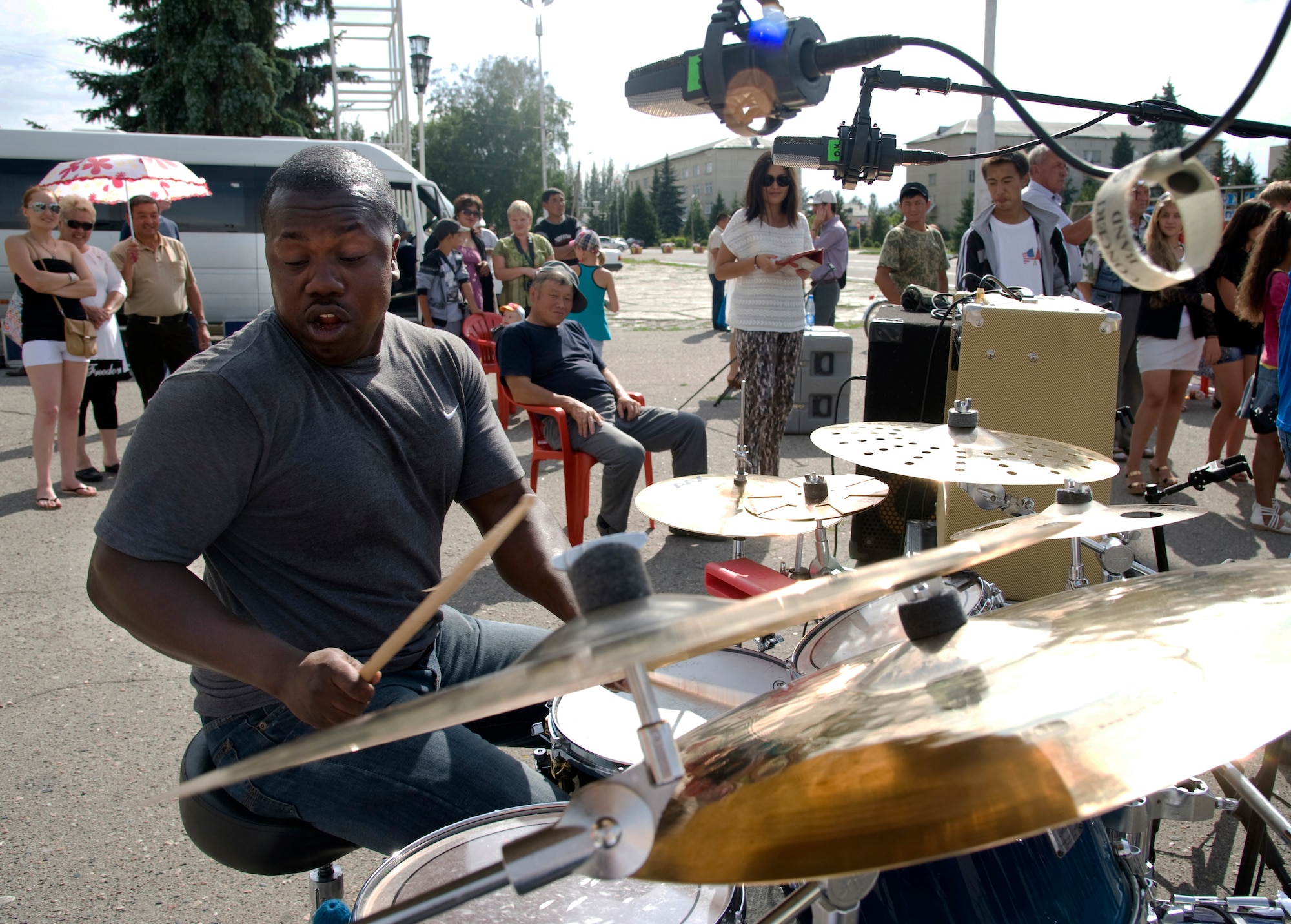 Technical Sgt. Edward Williams, U.S. Air Forces Central Command band, Full Spectrum drummer, performs in Karakol City central square, Kyrgyzstan, July 17, 2013. The AFCENT band’s performances were the highlight of an American Corners decennial celebration tour, sponsored by the U.S. Embassy, Bishkek. (U.S. Air Force photo/Staff Sgt. Krystie Martinez)