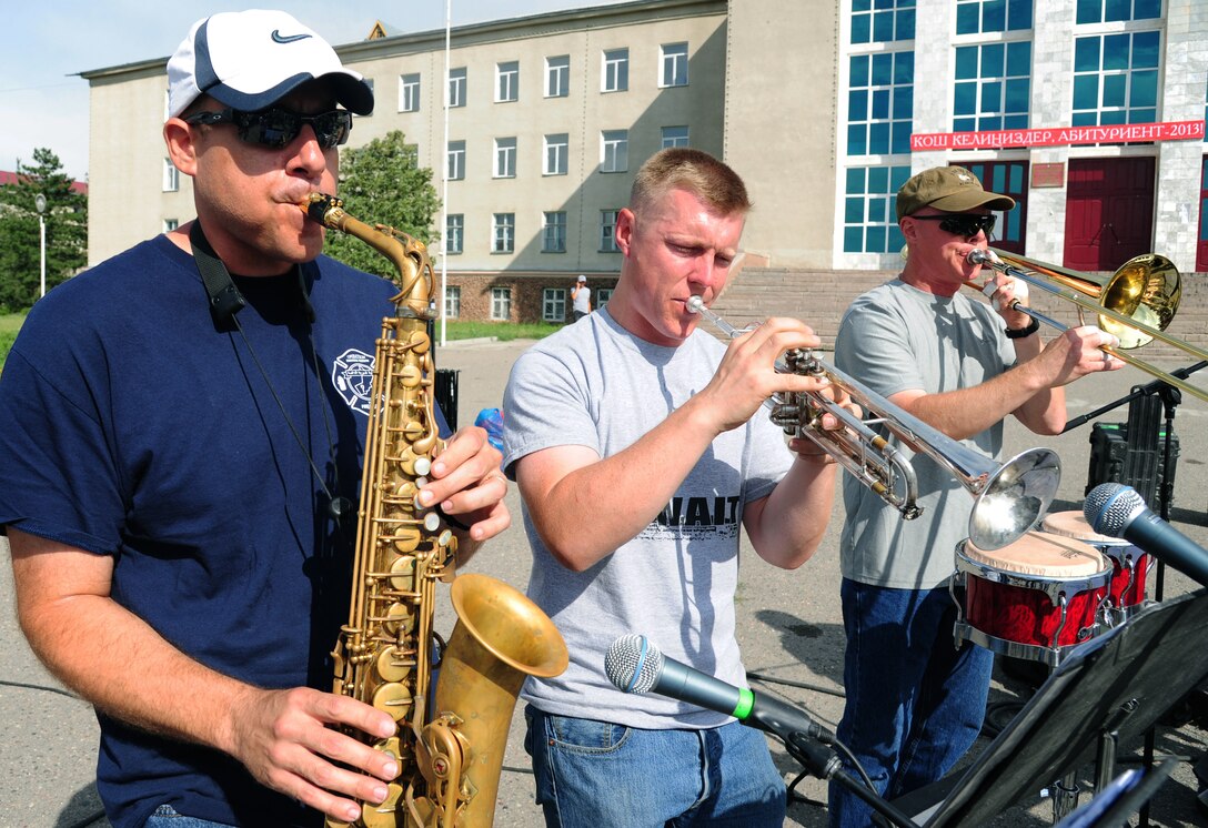 Technical Sgt. Christopher Stelling, left, Senior Airman Carl Stanley, center, and Master Sgt. John Cisar, right, U.S. Air Forces Central Command, Full Spectrum bandsmen, perform in Karakol City central square, Kyrgyzstan, July 17, 2013. The U.S. Embassy in Bishkek sponsored the five-day tour as part of a cultural exchange program called American Corners. The goal is to strengthen relationships between American and Kyrgyz people.  Full Spectrum is a 10-person band deployed from Joint Base Langley-Eustis, Va. (U.S. Air Force photo/Staff Sgt. Krystie Martinez)
