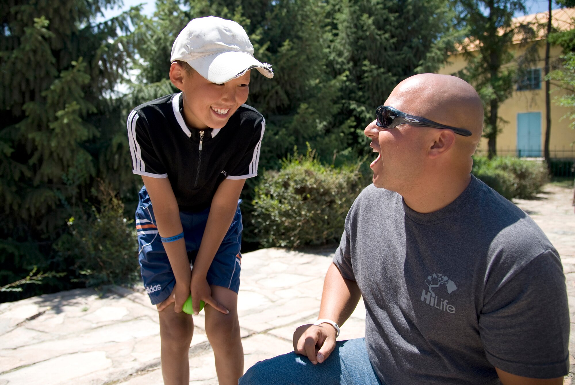 Technical Sgt. Richard Vasquez, U.S. Air Forces Central Command band, Full Spectrum vocalist, jokes with a Kyrgyz boy prior to performing at Bokonbaevo village, Kyrgyzstan, July 16, 2013. Full Spectrum toured local villages to bring a piece of American culture to Kyrgyz people. (U.S. Air Force photo/Staff Sgt. Krystie Martinez)