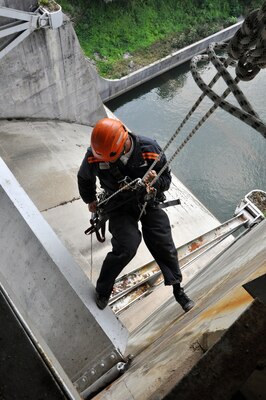 Chad Dahl, a member of the U.S. Army Corps of Engineers Special Rope Access Climb Team from the Philadelphia District lowers himself onto a concrete platform on the Wolf Creek Dam in Jamestown, Ky., as the team inspects the hydraulic radial gates and the structure for signs of corrosion and structual damages on July 24, 2013. 