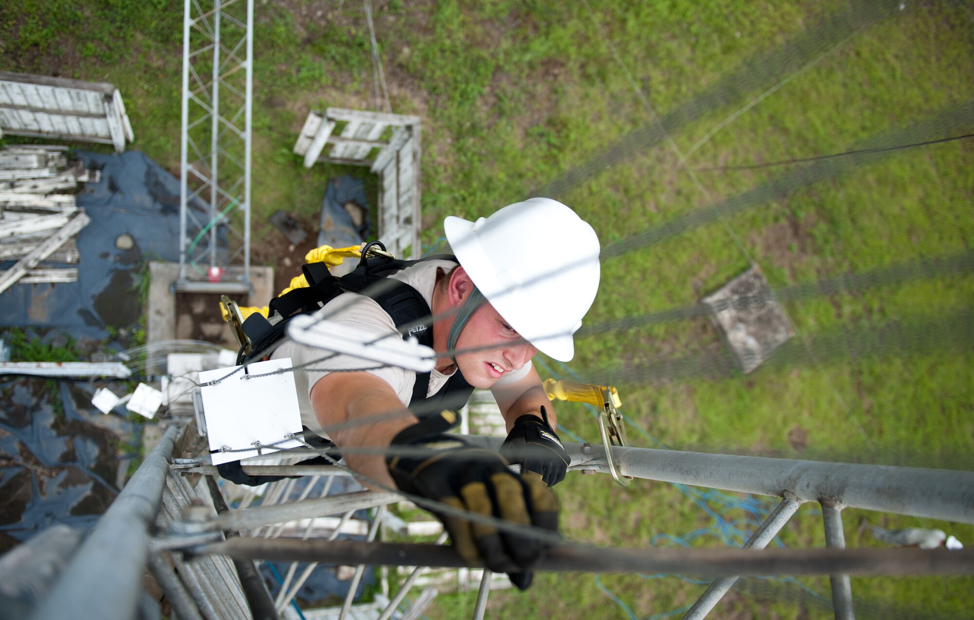Airman 1st Class Mike Turland, 374th Communications Squadron cable and antenna maintenance technician, climbs the stand to a rotatable log periodic antenna July 26, 2013, during scheduled maintenance at the Tokorozawa Communication Site, Japan. Turland wore a safely harness to prevent the possibility of falling and ensured he had three points of contact throughout the climb. (U.S. Air Force photo by Senior Airman Cody H. Ramirez)