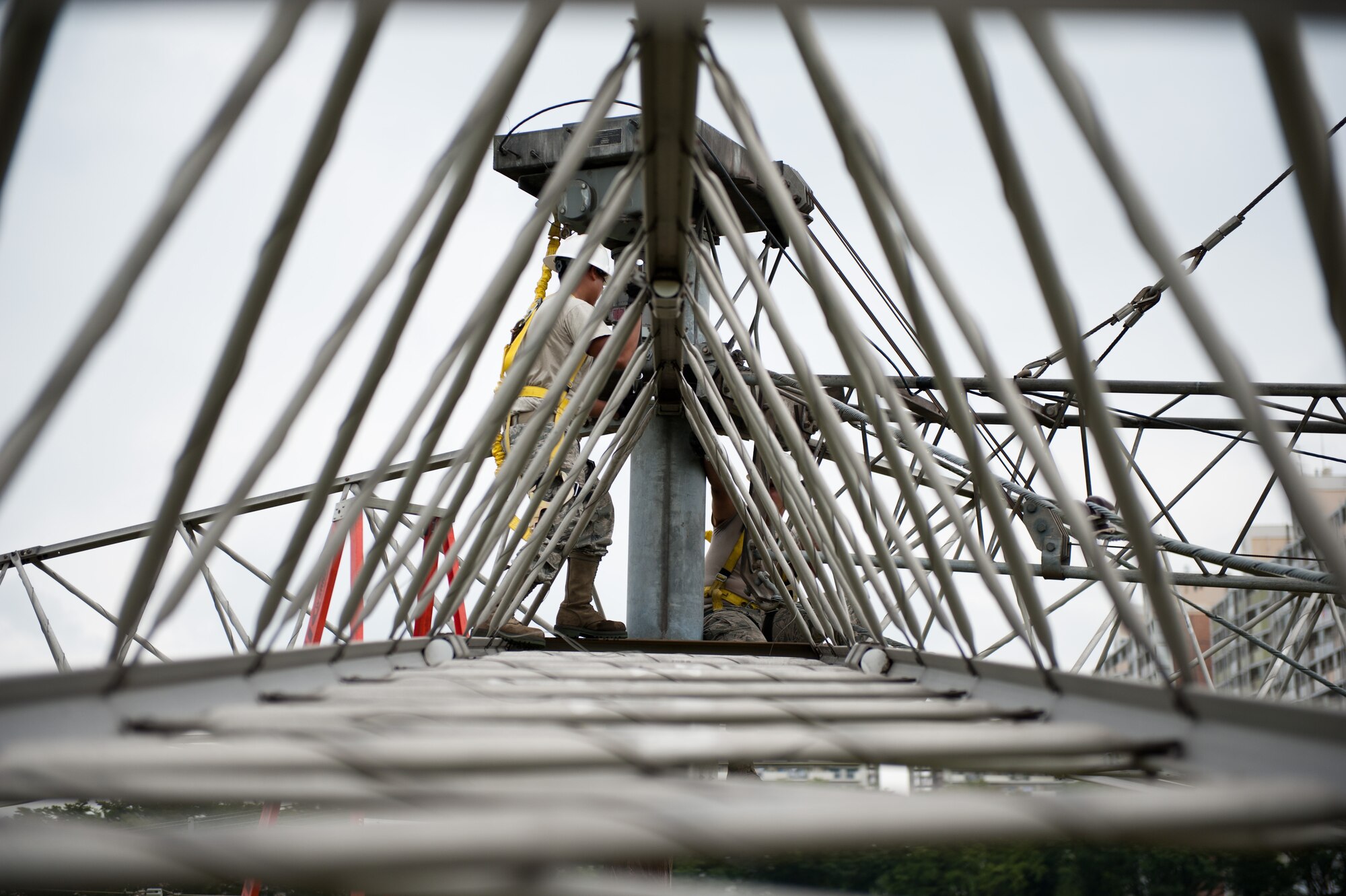 Airmen 1st Class David Herrera and Monico Viloria, 374th Communications Squadron cable and antenna maintenance technicians, work together to loosen a bolt on a rotatable log periodic antenna during scheduled maintenance July 26, 2013, at the Tokorozawa Communication Site, Japan. The antennas at Tokorozawa provide communication support to a variety of Department of Defense installations including Misawa Air Base and Yokosuka Naval Base. (U.S. Air Force photo by Senior Airman Cody H. Ramirez)