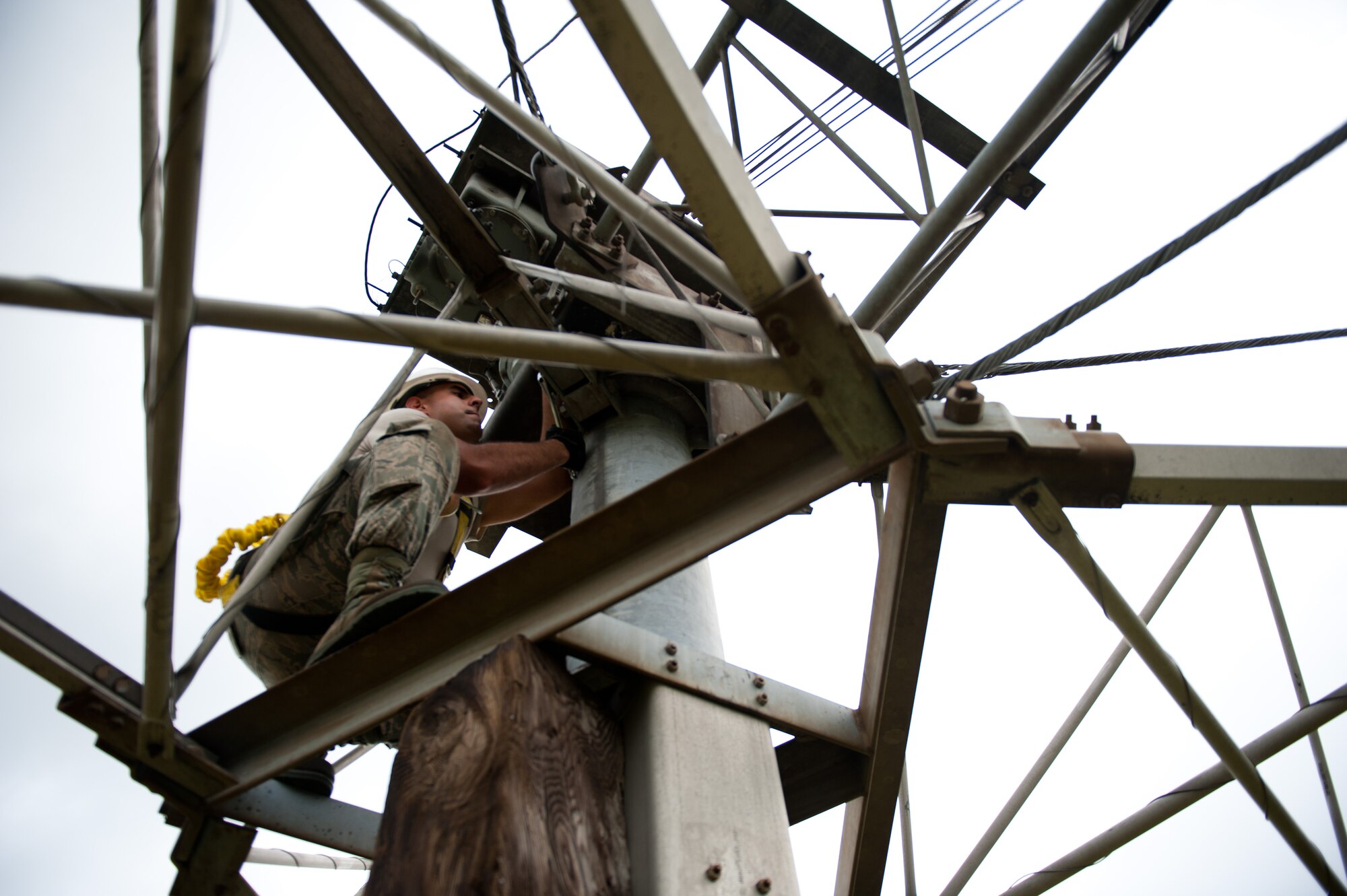 Airman 1st Class David Herrera, 374th Communications Squadron cable and antenna maintenance technician, loosens the bolt on a rotatable log periodic antenna during scheduled maintenance July 26, 2013, at the Tokorozawa Communication Site, Japan. Loosening the bolt allowed Herrera and his team to lay the antenna arm lower to the ground, making the replacement of crystalline plastic easier.  (U.S. Air Force photo by Senior Airman Cody H. Ramirez)