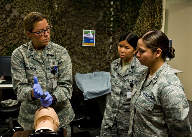 Capt. (Dr.) Brenna Shackelford, 99th Medical Operations Squadron staff emergency room physician, teaches Janice Perido and Jackie Soliz, 99th MDOS officer trainees  and physician assistant students, how to perform a tracheal intubation, July 24, 2013, at Nellis Air Force Base, Nev.  Intubation is the placement of a flexible plastic tube into the trachea to maintain an open airway. It is frequently performed in critically injured, ill or anesthetized patients to assist with breathing. (U.S. Air Force Photo by Airman 1st Class Jason Couillard)