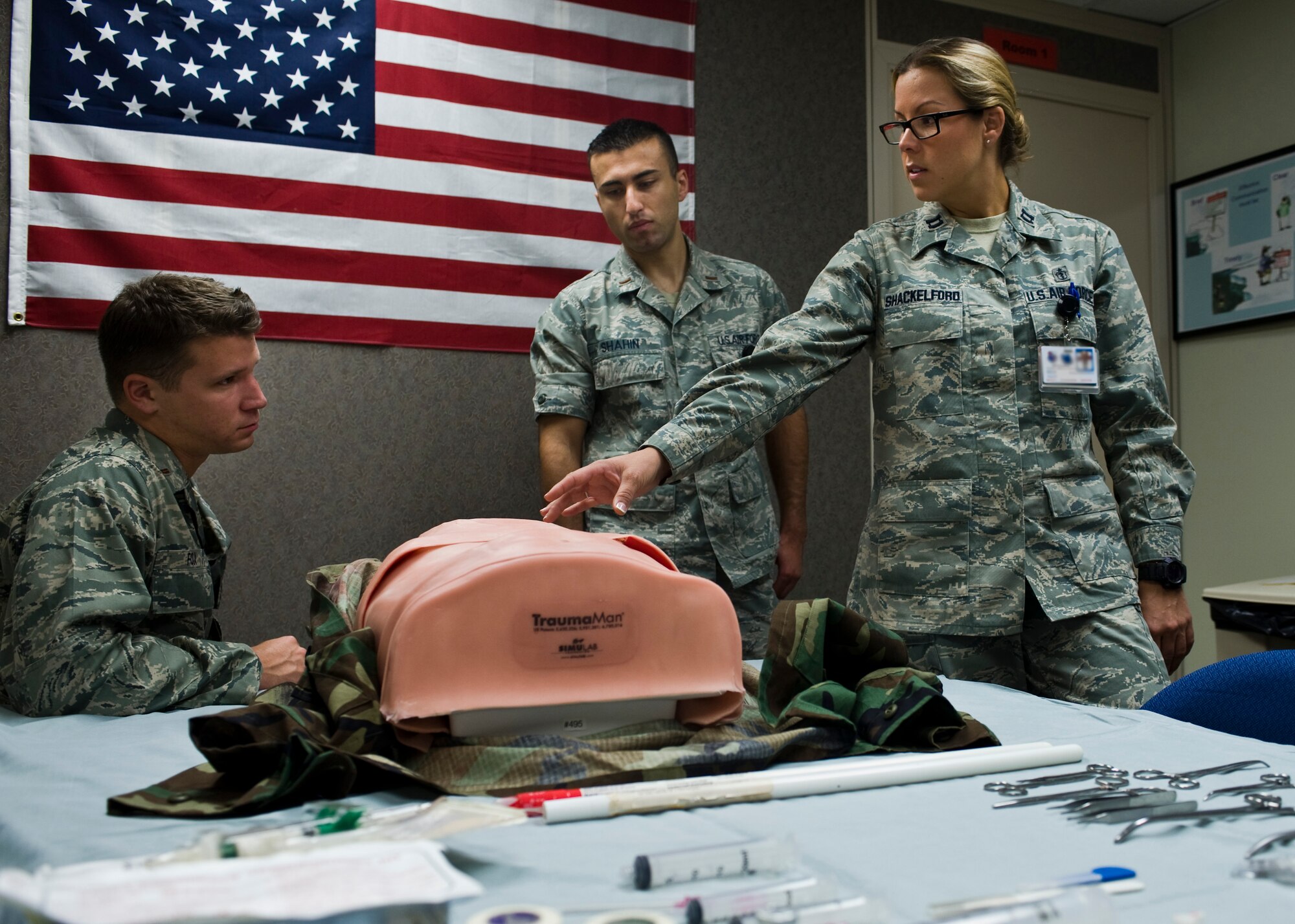 U.S. Air Force Capt. (Dr.) Brenna Shackelford, 99th Medical Operations Squadron staff emergency room physician, briefs medical residency students on high fidelity medical training mannequin functionality July 24, 2013, at Nellis Air Force Base, Nev. The residents learned how to perform a chest tube thoracostomy, which is done to drain fluid, blood or air from the space around the lungs. (U.S. Air Force Photo by Airman 1st Class Jason Couillard)