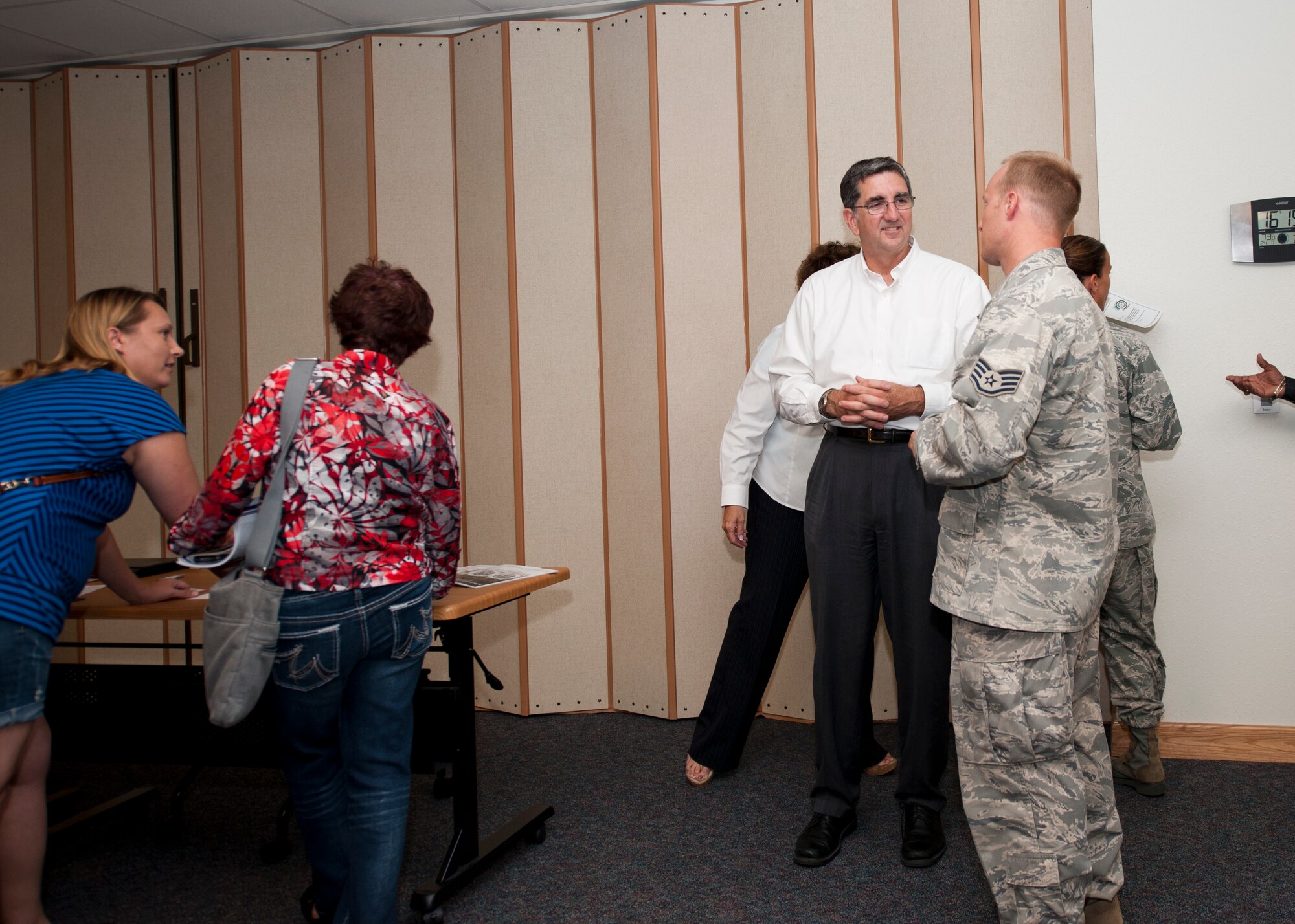 Tom Neubauer, Bay Defense Alliance president, specks with an Airman about his upcoming move to Tyndall Air Force Base, Fla., during an information session at Holloman Air Force Base, N.M., July 26. The Bay Defense Alliance organized the information session to assist Airman from Holloman in their transition and answer commonly asked questions about the area.(U.S. Air Force photo by Daniel E. Liddicoet/Released)