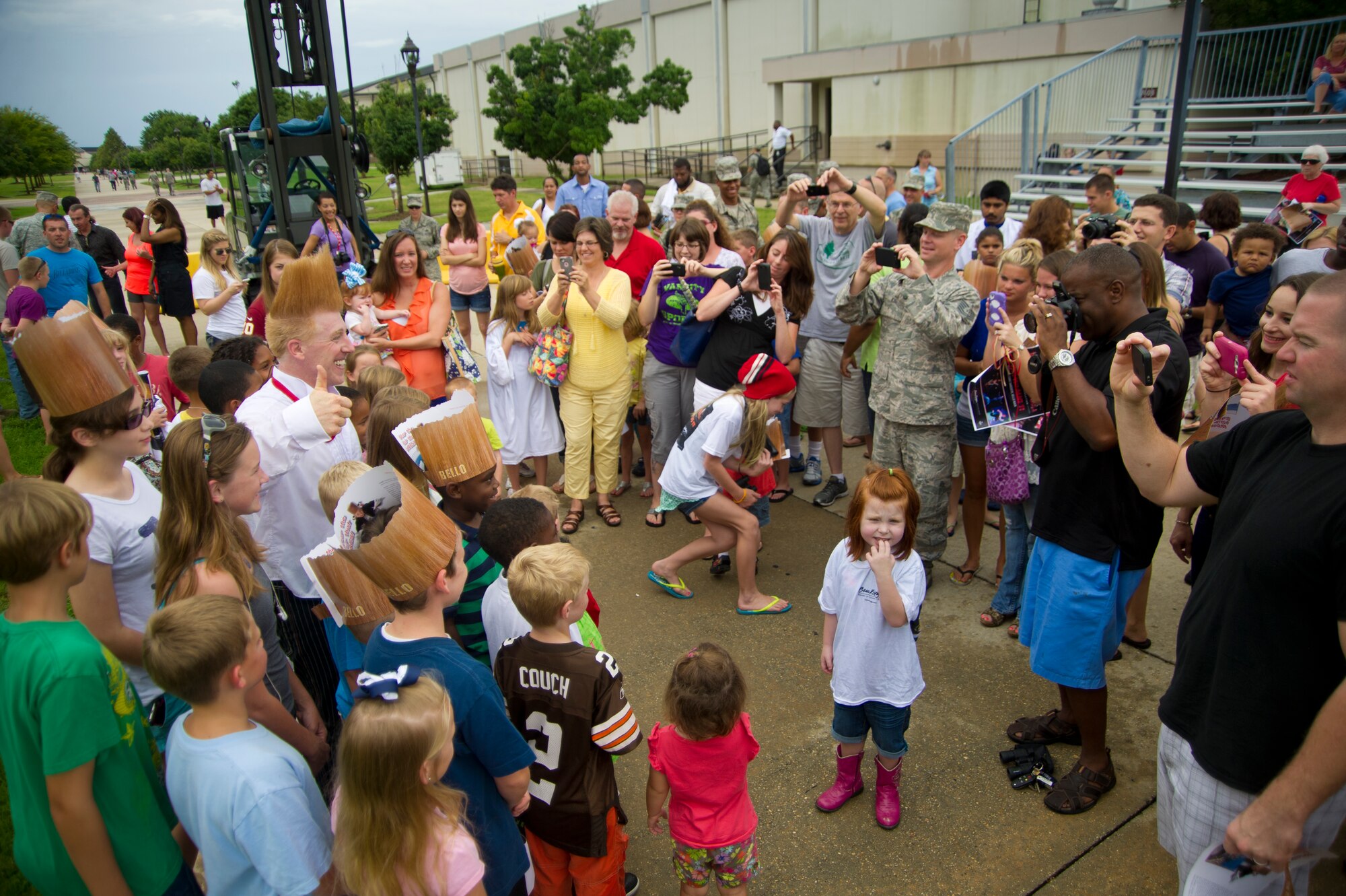 Parents take photos of their children with Bello Nock following a military appreciation performance of Funambula, July 27, 2013, at Welch Theater, Keesler Air Force Base, Miss. Funambula is a theatrical circus act including many acrobatic acts as well as contortionists. (U.S. Air Force photo by Adam Bond)