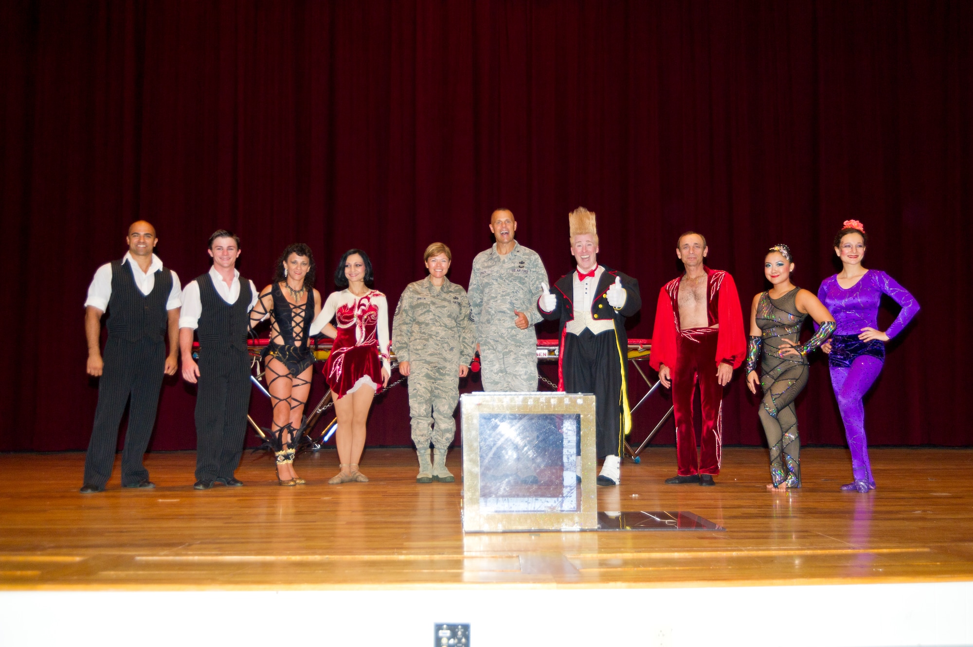 Chief Master Sgt. Angelica Johnson, 81 TRW command chief master sergeant, and Brig. Gen. Brad Spacy, 81 TRW commander, stand alongside the performers at the military appreciation showing of Funambula, July 27, 2013, at Welch Theater, Keesler Air Force Base, Miss. Funambula is a theatrical circus act including many acrobatic acts as well as contortionists. (U.S. Air Force photo by Adam Bond)