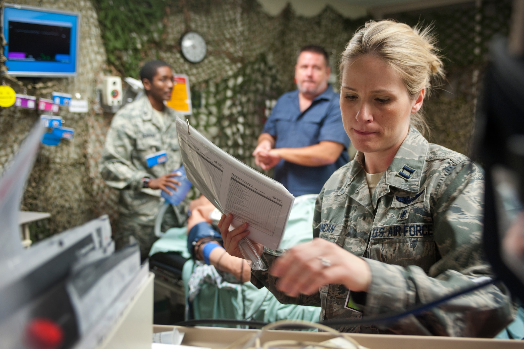 U.S. Air Force Capt. Jennifer Duncan, 99th IPTS outpatient critical care nurse, gathers instruments necessary to conduct an advanced cardiac life support training simulation with the use of an ISTAN 370 high fidelity mannequin at the Nellis Medical Simulation Center July 29, 2013, at Nellis Air Force Base, Nev. The Mike O’Callaghan Federal Medical Center started a foundation for a medical simulation center to accommodate the need for a more realistic training in January 2009.  (U.S. Air Force photo by Staff Sgt. Christopher Hubenthal)