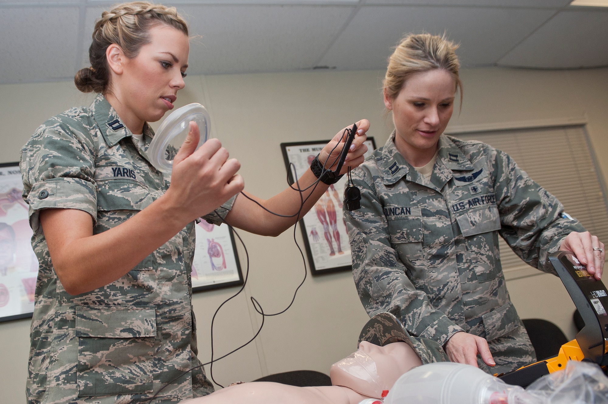 U.S. Air Force Capt. Laura Yaris, 99th Inpatient Squadron inpatient critical care nurse, and Capt. Jennifer Duncan, 99th IPTS outpatient critical care nurse, practice advanced cardiac life support procedures during an ACLS training course at the Nellis Medical Simulation Center July 29, 2013, at Nellis Air Force Base, Nev. The goal of ACLS training at the Nellis Medical Simulation Center is to teach medical staff how to restore ventilation, oxygenation and circulation to a victim experiencing cardiac arrest or cardiopulmonary emergencies. (U.S. Air Force photo by Staff Sgt. Christopher Hubenthal)