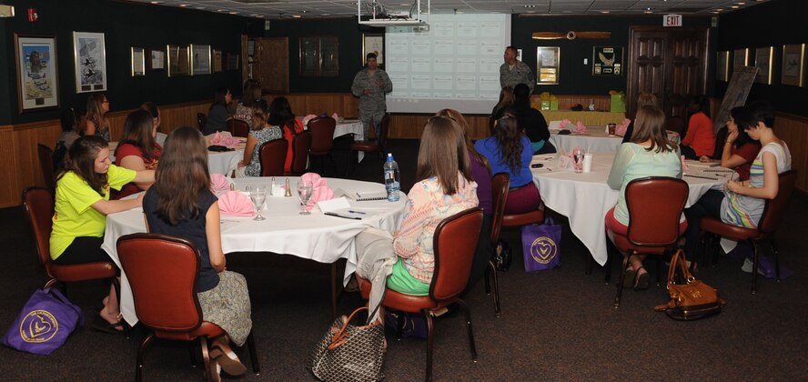 Col. Andrew Gebara, 2nd Bomb Wing commander, and Chief Master Sgt. Curtis Storms, 2nd BW command chief, give a presentation at the Heart Link, Air Force 101 for Spouses class on Barksdale Air Force Base, La., July 25, 2013. The class is held to provide new Air Force spouses a better understanding about the Air Force way of life. (U.S. Air Force photo/Senior Airman Sean Martin)