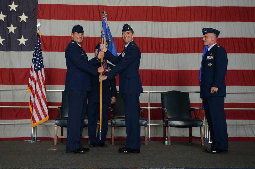 U.S. Air Force Col. Dean Borsos, outgoing 20th Medical Group commander, watches as U.S. Air Force Col. Clay Hall, 20th Fighter Wing commander, presents U.S. Air Force Col. Curt Prichard, incoming 20th MDG commander, with the guide-on, during a change-of-command ceremony at Shaw Air Force Base, S.C., July 29, 2013. Borsos will depart to be the Air Force Medical Support Agency vice commander at the Defense Health Headquarters, Falls Church, Va. (U.S. Air Force photo by Airman 1st Class Krystal M. Jeffers/Released)