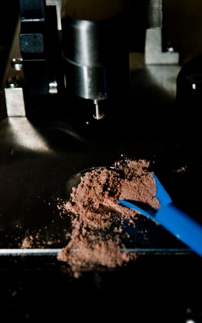 U.S. Air Force Senior Airman Nicholas Johnson, 99th Aerospace Medicine Squadron bioenvironmental engineer journeyman, tests protein powder while training on a hazardous material identification machine July 29, 2013, at Nellis Air Force Base, Nev. The HazmatID machine enables Bioenvironmental Airmen to test unknown substances during a mishap to determine if they are hazardous. (U.S. Air Force photo by Senior Airman Daniel Hughes)  