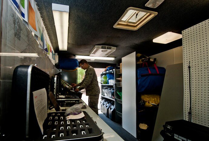 U.S. Air Force Senior Airman Nicholas Johnson, 99th Aerospace Medicine Squadron bioenvironmental engineer journeyman, looks at the emergency response equipment in the bioenvironmental emergency response trailer July 29, 2013, at Nellis Air Force Base, Nev. The trailer is the staging point for bioenvironmental Airmen during mishaps and also holds all of their equipment. (U.S. Air Force photo by Senior Airman Daniel Hughes)  
