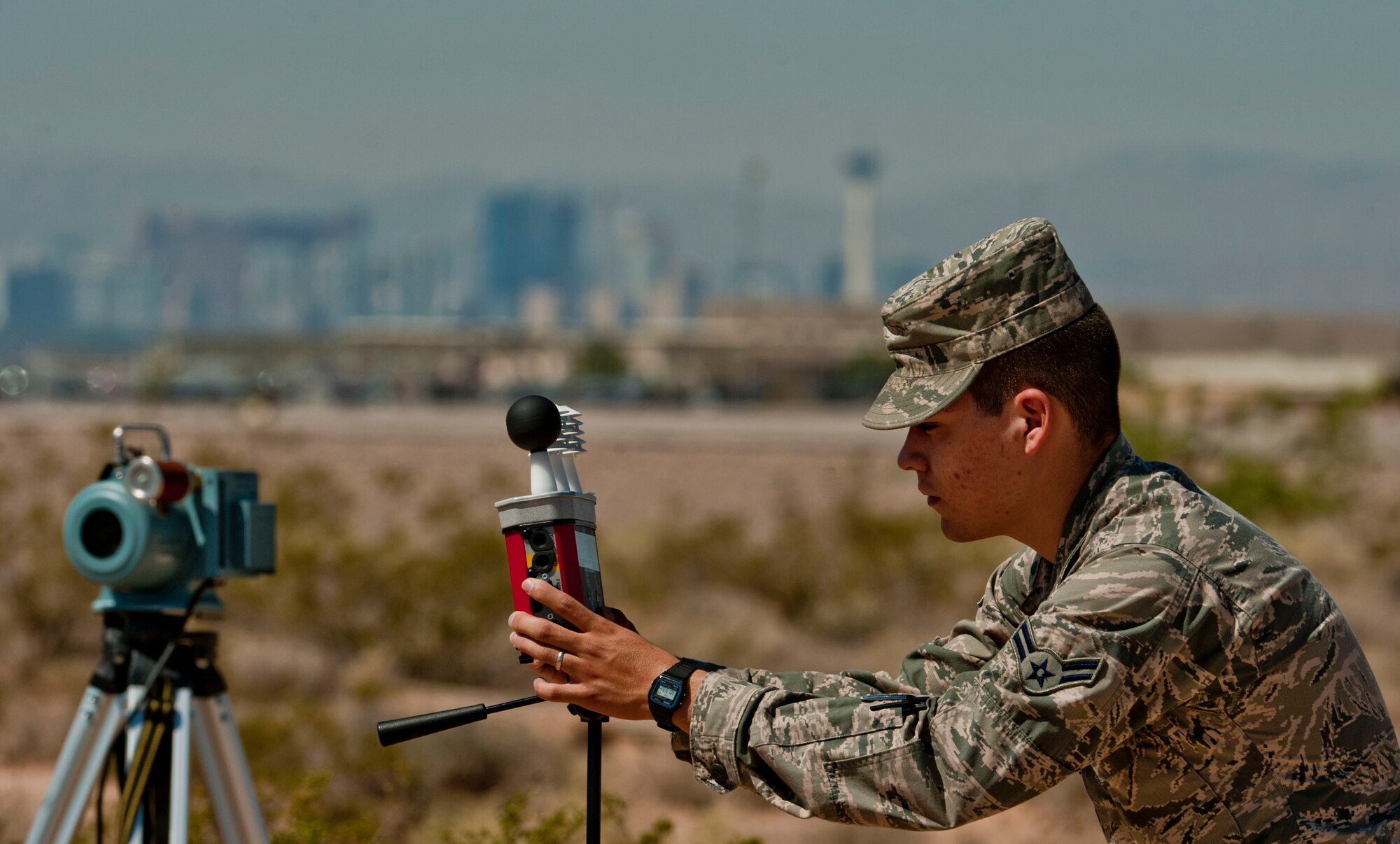 U.S. Air Force Airman 1st Class Joshua Arteaga, 99th Aerospace Medicine Squadron bioenvironmental engineer apprentice, uses a wet bulb globe temperature machine July 25, 2013, at Nellis Air Force Base, Nev. The WBGT gauges what the thermal heat feels like in our body and is used during a first response in case of excessive heat to help determine an acceptable work cycl. (U.S. Air Force photo by Senior Airman Daniel Hughes)