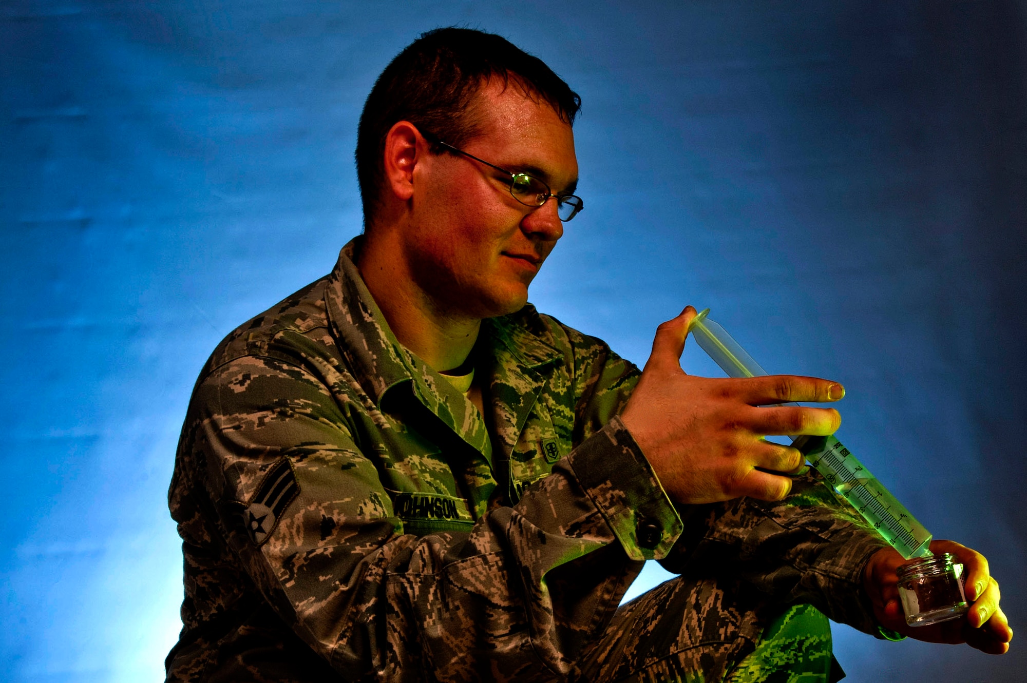 U.S. Air Force Senior Airman Nicholas Johnson, 99th Aerospace Medicine Squadron bioenvironmental engineer journeyman, squeezes a water sample from a syringe into a test container July 23, 2013, at Nellis Air Force Base, Nev. Bioenvironmental Airmen take samples of substances at mishap scenes to gather information to ensure the safety of the people who may enter a contaminated environment that may have been exposed to harmful substances. (U.S. Air Force photo by Senior Airman Daniel Hughes)  