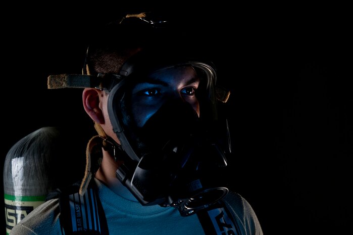 U.S. Air Force Airman 1st Class Joshua Arteaga, 99th Aerospace Medicine Squadron bioenvironmental engineer apprentice, wears a gas/oxygen mask used by first responders during emergency response in the event of a mishap July 23, 2013, at Nellis Air Force Base, Nev. The gas/oxygen mask is worn under a level A suit, which protects Airmen from hazards ranging from chemical, biological, radiological or nuclear exposure when working around unknown materials. (U.S. Air Force photo by Senior Airman Daniel Hughes)