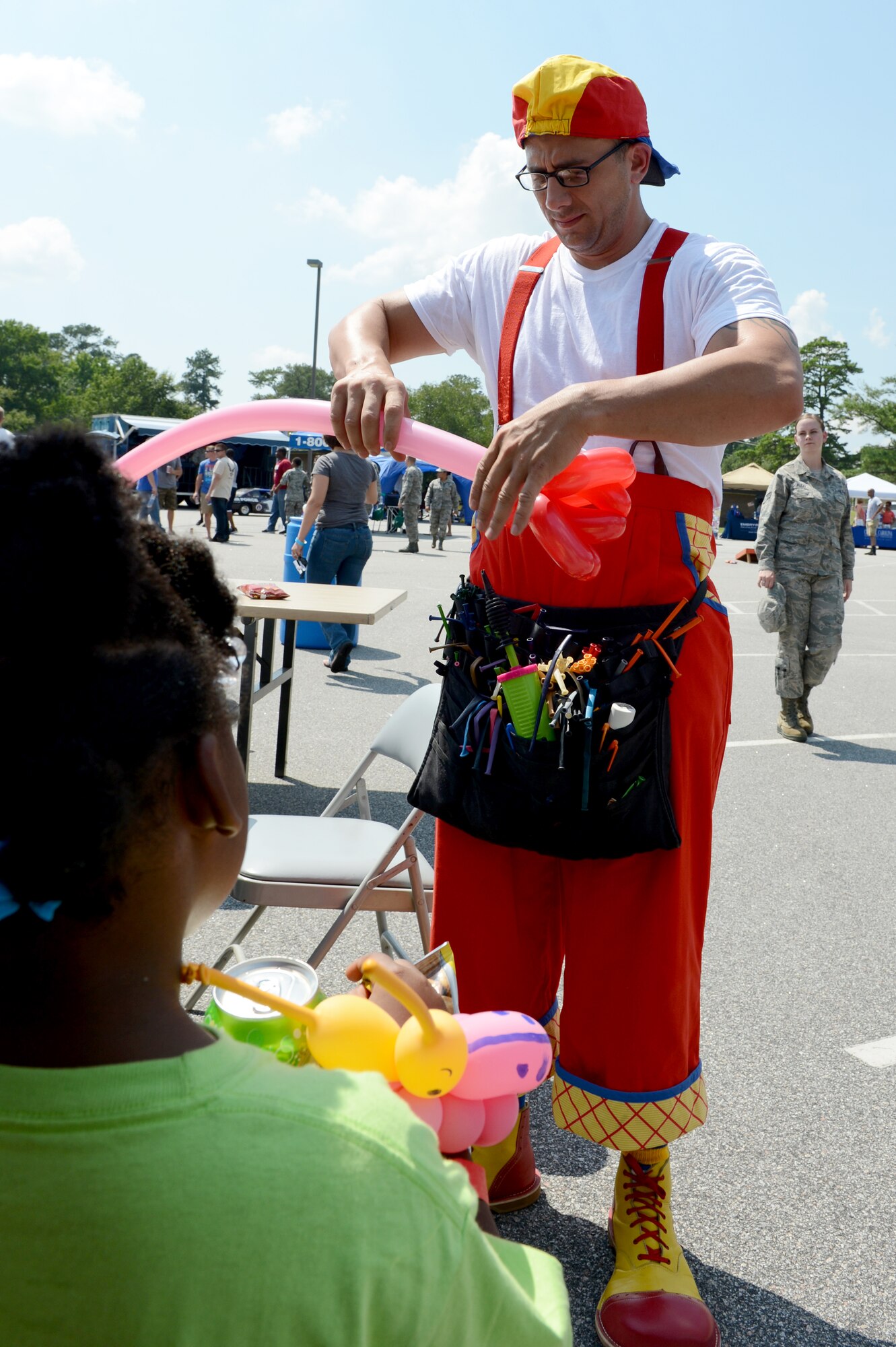 U.S. Air Force Tech. Sgt. Michael Rosiere, 337th Recruiting Squadron recruiter, makes a balloon rose during the Junior Enlisted Appreciation Day Celebration at Shaw Air Force Base, S.C., July 26, 2013. The clown was one of the many attractions at the celebration hosted by Team Shaw’s Top 3. (U.S. Air Force photo by Airman 1st Class Krystal M. Jeffers/Released)