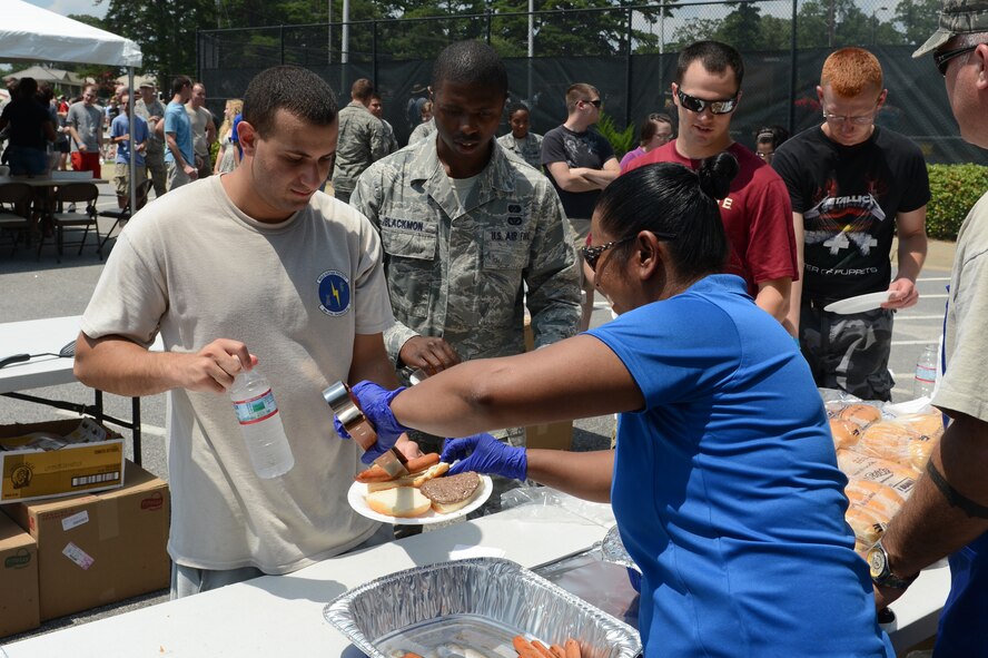 U.S. Air Force Master Sgt. Melissa Wheeler, 20th Equipment Maintenance Squadron First Sergeant ,  serves food during the Junior Enlisted Appreciation Day Celebration at Shaw Air Force Base, S.C., July 26, 2013. The celebration, hosted by Team Shaw’s Top 3, offered junior enlisted service members an afternoon of free food, activities and events.. (U.S. Air Force photo by Airman 1st Class Krystal M. Jeffers/Released) 