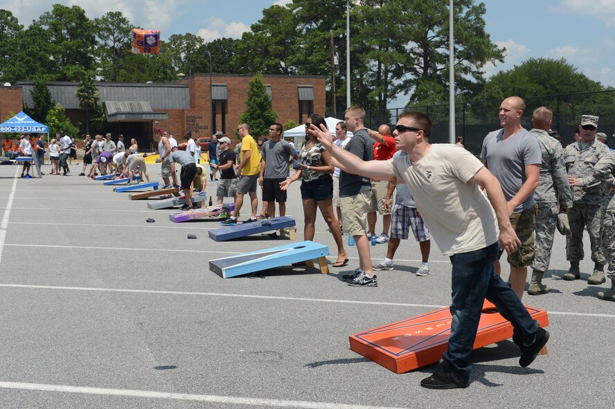 U.S. Air Force Senior Airman Karl Deffert, 20th Contracting Squadron contracting  officer, plays cornhole at the Junior Enlisted Appreciation Day Celebration at Shaw Air Force Base, S.C., July 26, 2013. The celebration, hosted by Team Shaw’s Top 3, offered junior enlisted service members an afternoon of free food, activities and events.. . (U.S. Air Force photo by Airman 1st Class Krystal M. Jeffers/Released)
