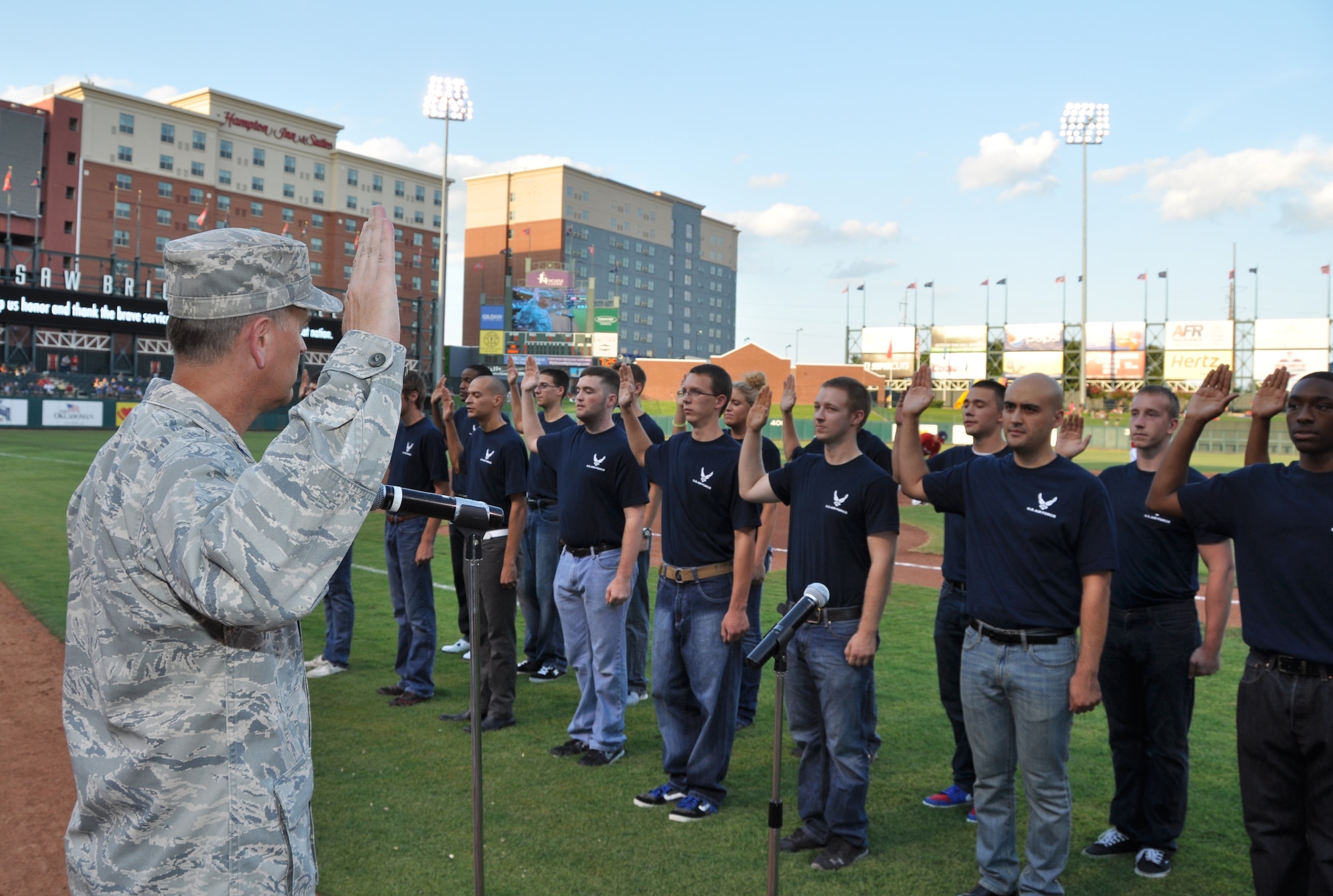 Colonel Russell Muncy, 507th Air Refueling Wing commander administers the Oath of Enlistment to 26 new Air Force Recruits at the Oklahoma City RedHawks game on July 27. The new recruits are all scheduled to attend basic military training with in a year. (U.S. Air Force Photo/Maj. Jon Quinlan) 