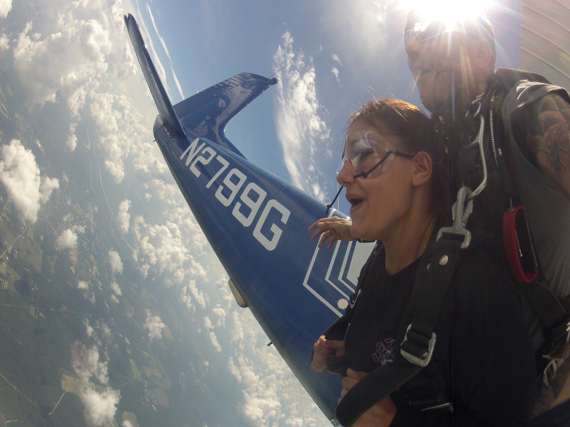 Airman 1st Class Drew Folks, a cyber-transport systems technician with 1st Special Operations Communications Squadron, jumps in tandem with an instructor of Skydive Panama City right outside their plane during a trip to their station at Altha, Florida, July 27, 2013.  Folks and fellow junior enlisted Airmen participated in the trip as part of the base's Single Airman Initiative Program. (Courtesy photo)