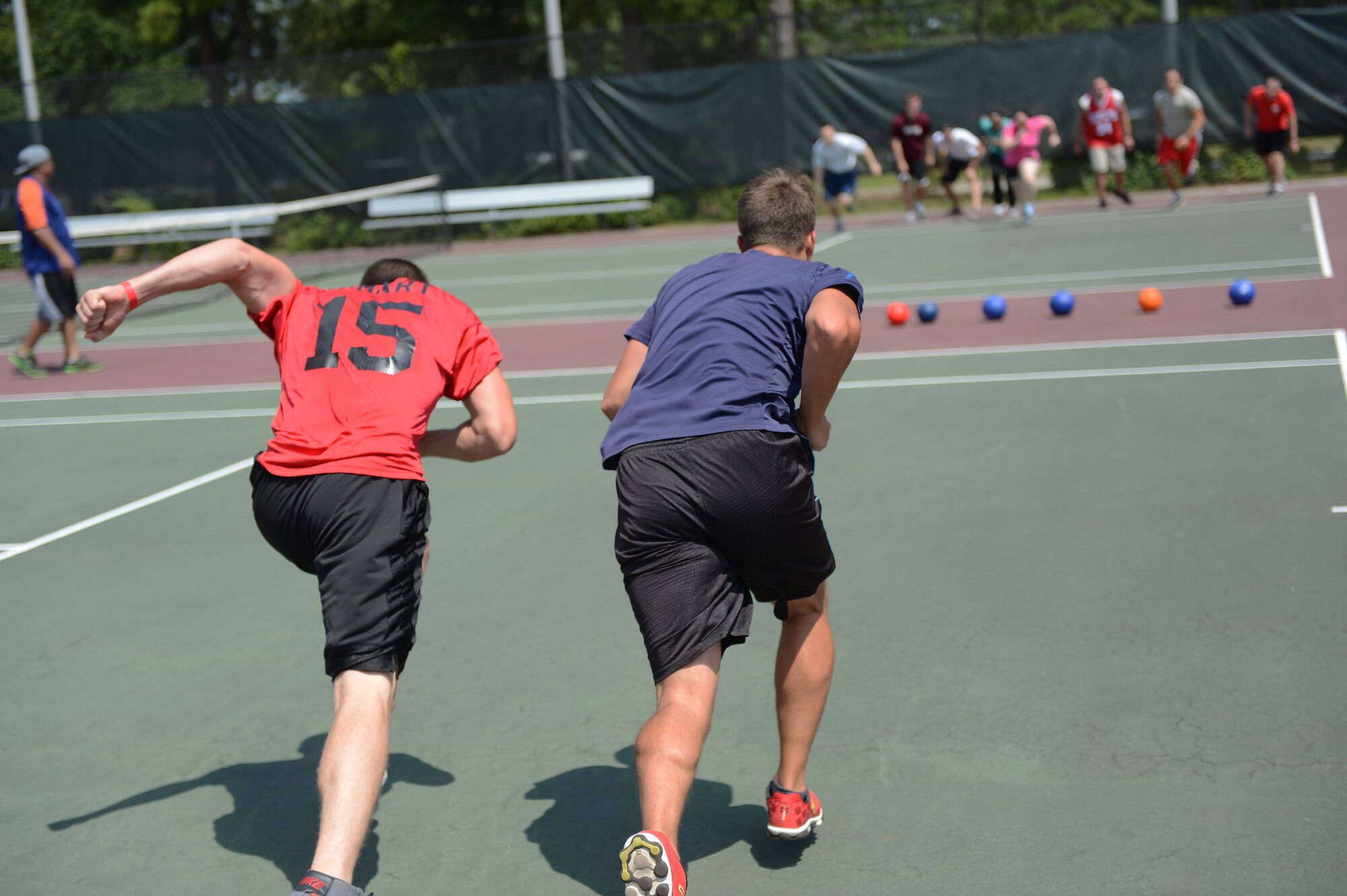 U.S. Air Force Airmen from the 609th Air Operations Center (foreground) sprint toward the line of dodge balls during a tournament at the Junior Enlisted Appreciation Day, Shaw Air Force Base, S.C., July 26, 2013. Shaw’s JEAD honored the work of Airmen and Soldiers, grades E-1 to E-5, for their role in supporting the bases’ missions and daily operations. (U.S. Air Force photo by Airman 1st Class Daniel Blackwell/Released)