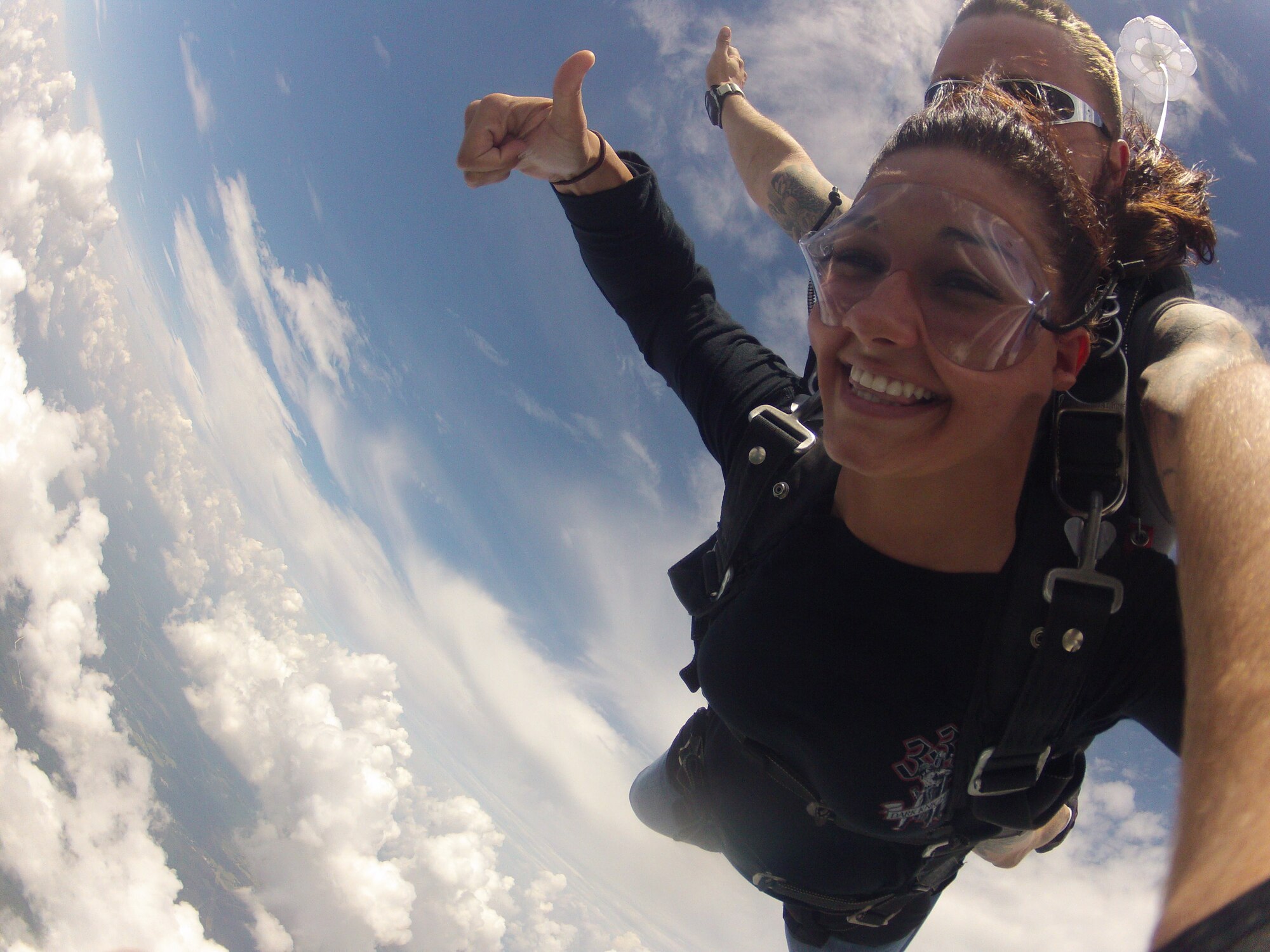 Airman 1st Class Drew Folks, a cyber-transport systems technician with 1st Special Operations Communications Squadron, skydives in tandem with an instructor of Skydive Panama City during a trip to their station at Altha, Florida, July 27, 2013.  Airmen participating in the jump with an instructor jumped 10,000 feet from a small plane and landed via parachute back at the plane's station. (Courtesy photo)