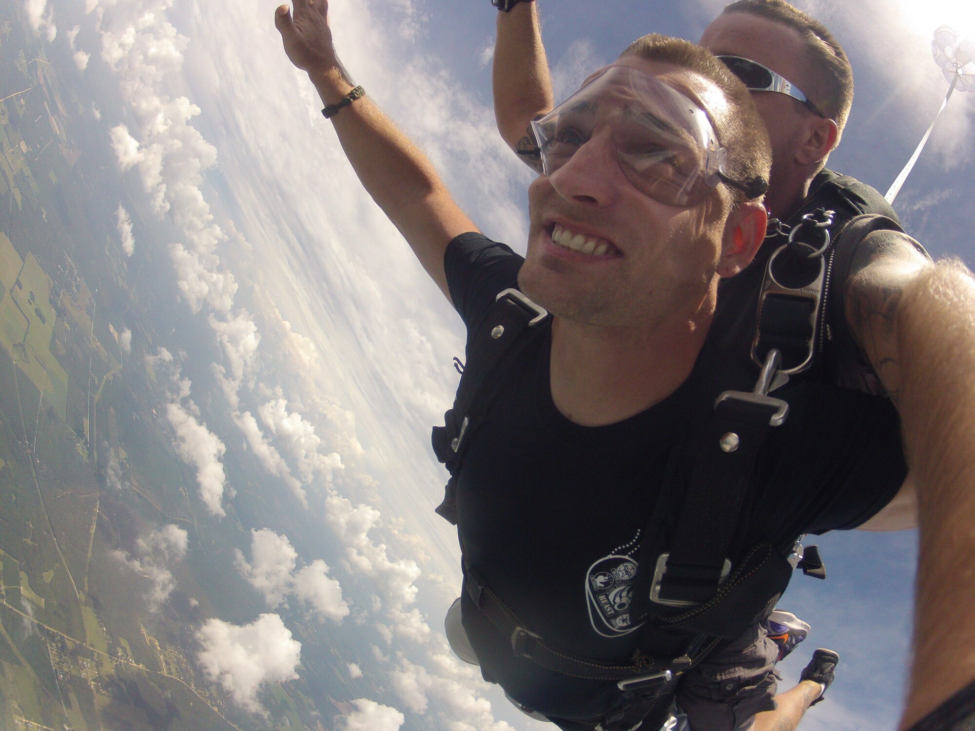 Airman 1st Class Fletcher Reed, an electric power production apprentice of 1st Special Operations Civil Engineer Squadron, skydives in tandem with an instructor of Skydive Panama City during a trip to their station at Altha, Florida, July 27, 2013.  Nearly 20 Airmen participated in the 10,000 foot drop and parachute landing as part of the Single Airman Initiative Program. (Courtesy photo)