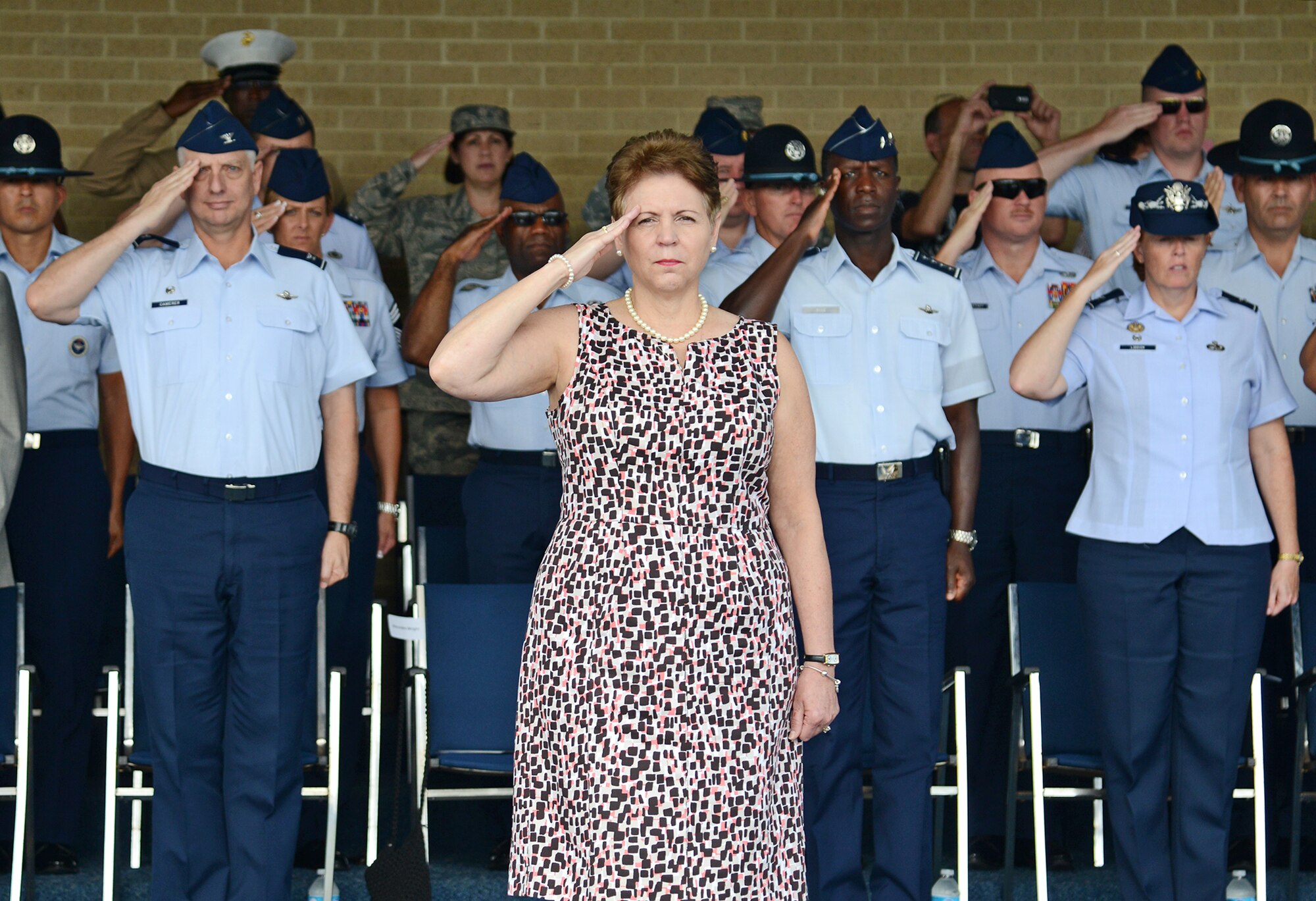 The Honorable Jessica L. Wright, acting under secretary of defense for personnel and readiness, renders a salute during pass in review at the basic military training parade July 19, at Joint Base San Antonio-Lackland. (U.S. Air Force photo by Benjamin Faske) 


