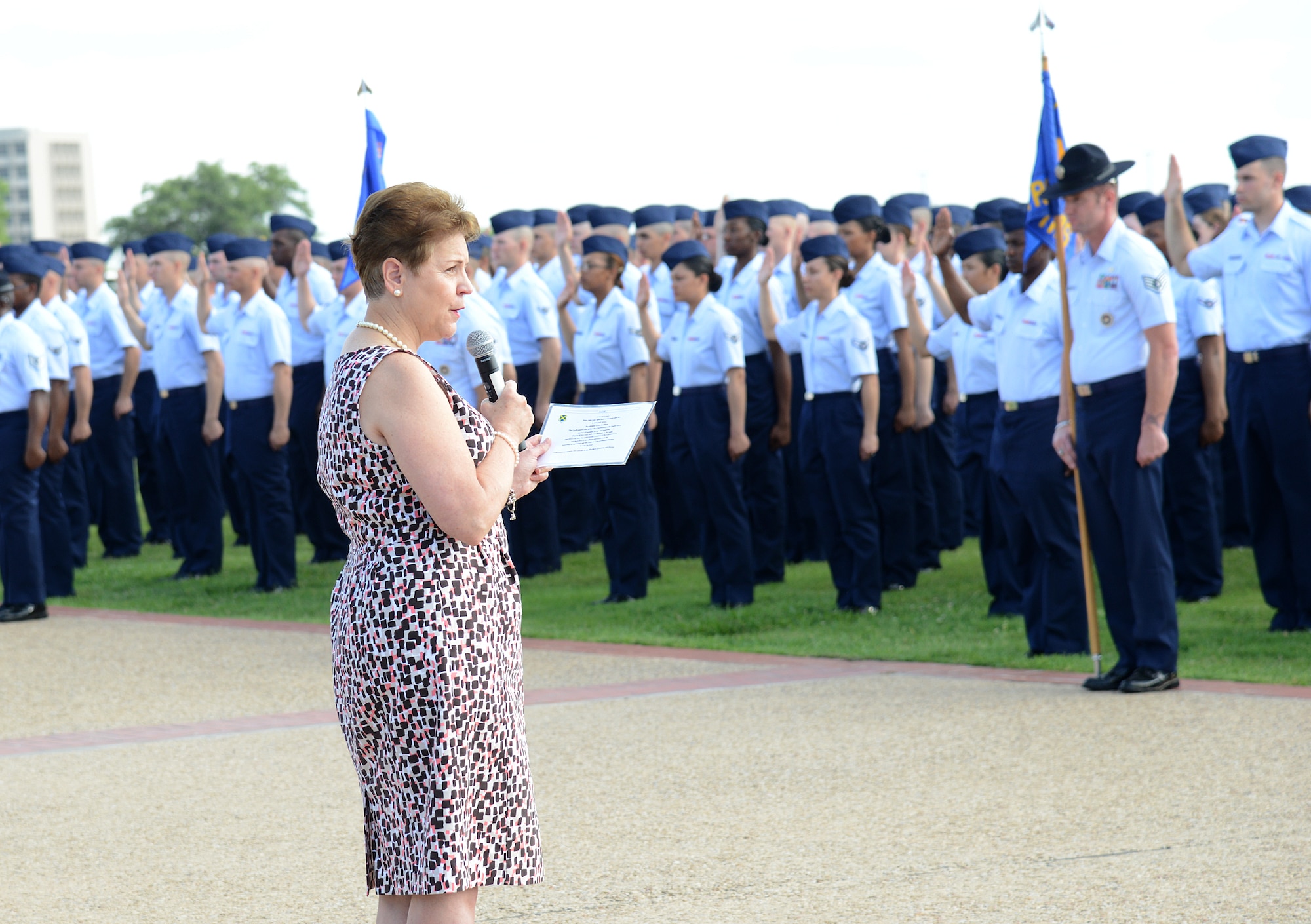 The Honorable Jessica L. Wright, acting under secretary of defense for personnel and readiness,  gives the oath of enlistment at the basic military training parade July 19, at Joint Base San Antonio-Lackland. (U.S. Air Force photo by Benjamin Faske) (released)