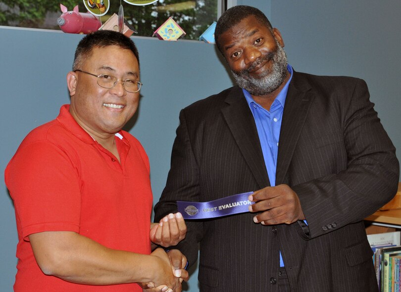 Master Sgt. Cristofer Valenzuela, 495th Fighter Group, Detachment 303, first sergeant, receives an award from Linwood Mason, secretary of the local Toastmasters International chapter at the Knob Noster Library, July 29. Valenzuela has been active with Toastmasters for several years and is a former president of the chapter. (U.S. Air Force photo by Senior Airman Wesley Wright/released)
