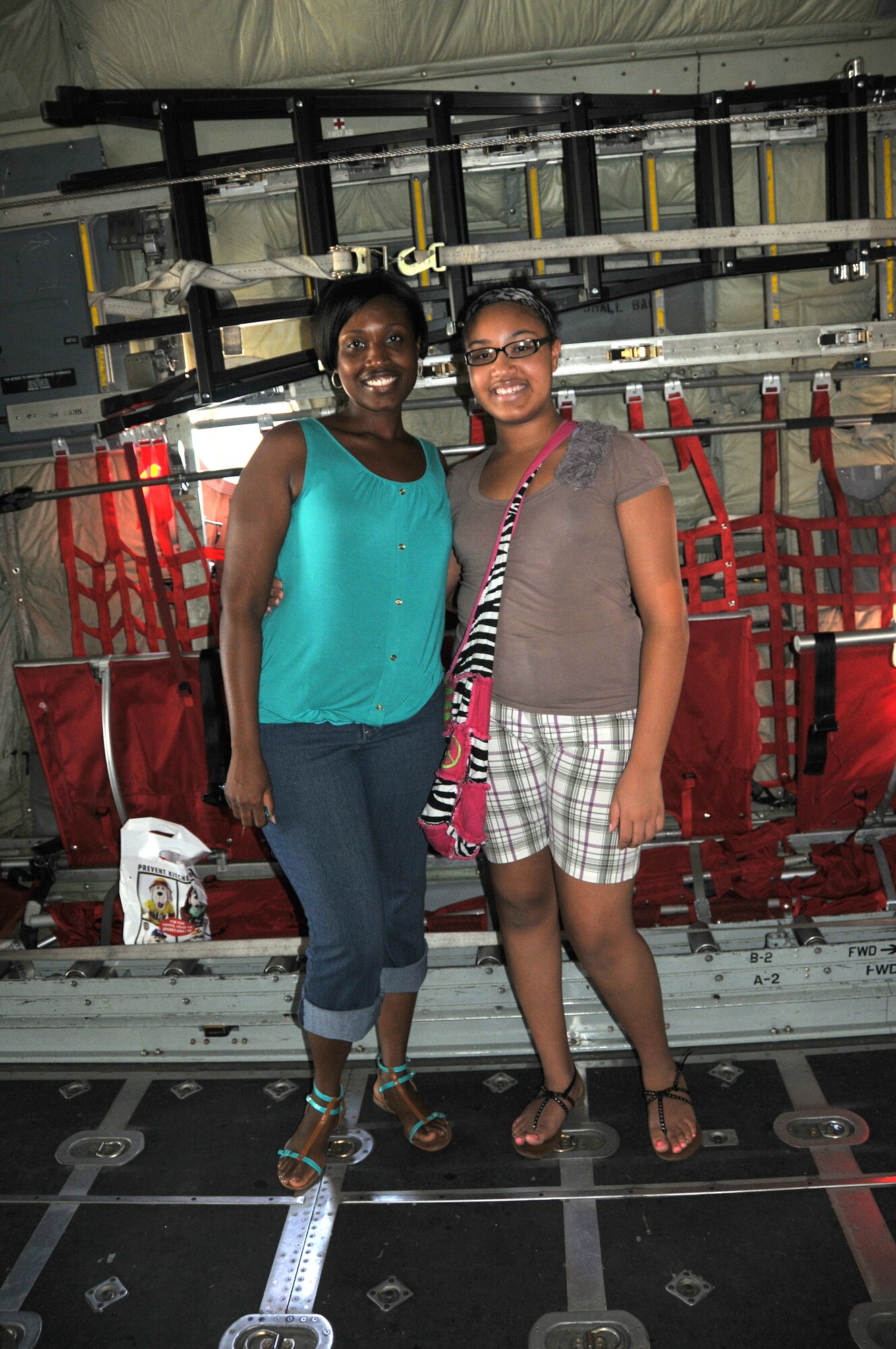 Shonda Hayes, 94th Aeromedical Staging Squadron medical administrative assistant, and her daughter attend Bring Your Kid to Work Day 2013 on July 25 at Dobbins Air Reserve Base. Hayes was able to show her duaghter where she works, several displays of mitary weapons systems and have a little fun with dodgeball. (U.S. Air Force photo/Senior Airman Elizabeth Van Patten)