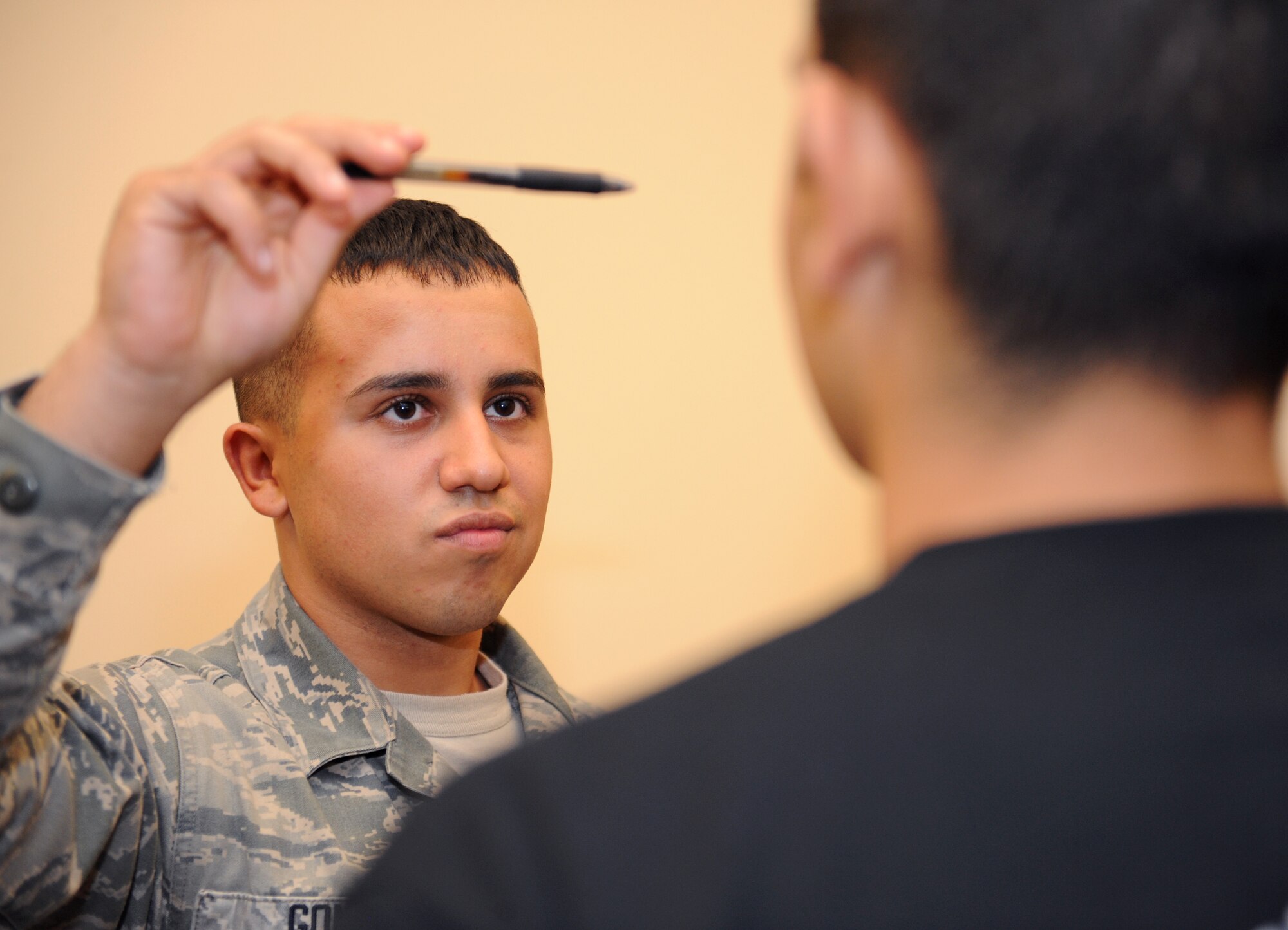 Airman 1st Class Caleb Gomez, 2nd Security Forces Squadron patrolman, performs a horizontal line test during standardized field sobriety test training on Barksdale Air Force Base, La., July 24, 2013. The horizontal line test, also known as the horizontal gaze nystagmus, is used on possible impaired drivers to check the jerking movements of their eyes as an object is moved across their line of sight. (U.S. Air Force photo/Airman 1st Class Benjamin Gonsier)
