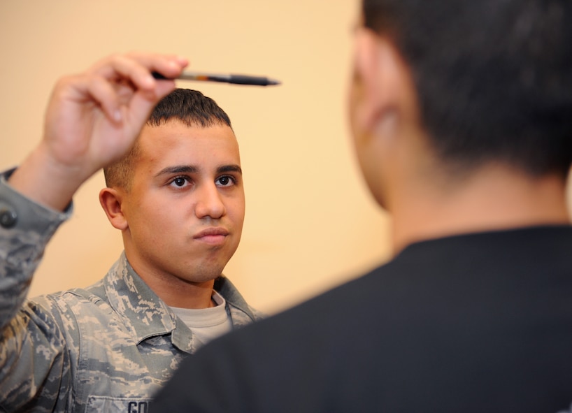 Airman 1st Class Caleb Gomez, 2nd Security Forces Squadron patrolman, performs a horizontal line test during standardized field sobriety test training on Barksdale Air Force Base, La., July 24, 2013. The horizontal line test, also known as the horizontal gaze nystagmus, is used on possible impaired drivers to check the jerking movements of their eyes as an object is moved across their line of sight. (U.S. Air Force photo/Airman 1st Class Benjamin Gonsier)