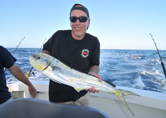 U.S. Army Sgt. First Class Patrick Fry, flight operations Soldier with the 57th Troop Command, New Jersey Army National Guard, holds a mahi mahi he caught aboard the Canyon Runner fishing charter boat at the Hudson Canyon, Atlantic Ocean on July 3, 2013. (U.S. Air National Guard Photo by Master Sgt. Andrew J. Moseley, Released)