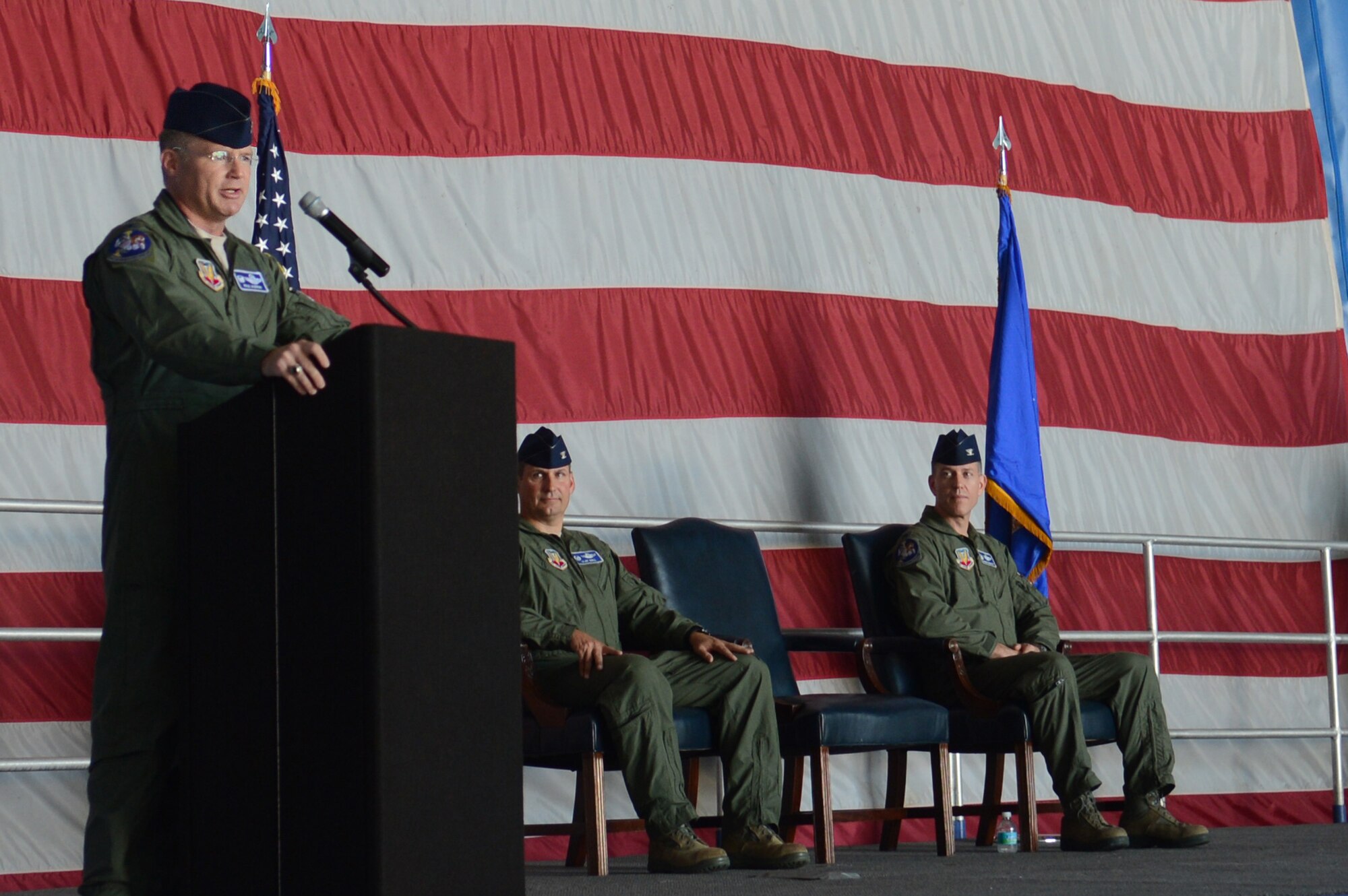 Incoming 20th Operations Group Commander, U.S. Air Force Col. Paul Murray, addresses the crowd after receiving command of the 20th OG as U.S. Air Force Col. Clay Hall (middle), 20th Fighter Wing commander, and U.S. Air Force Col. Shaun McGrath, outgoing 20th OG commander, listen to his speech during a change-of-command ceremony at Shaw Air Force Base, S.C. July 26, 2013. McGrath commanded the 20th OG for 16 months and will depart to take command of an Expeditionary Operations Group at an undisclosed location. (U.S. Air Force photo by Airman 1st Class Jonathan Bass/Released)