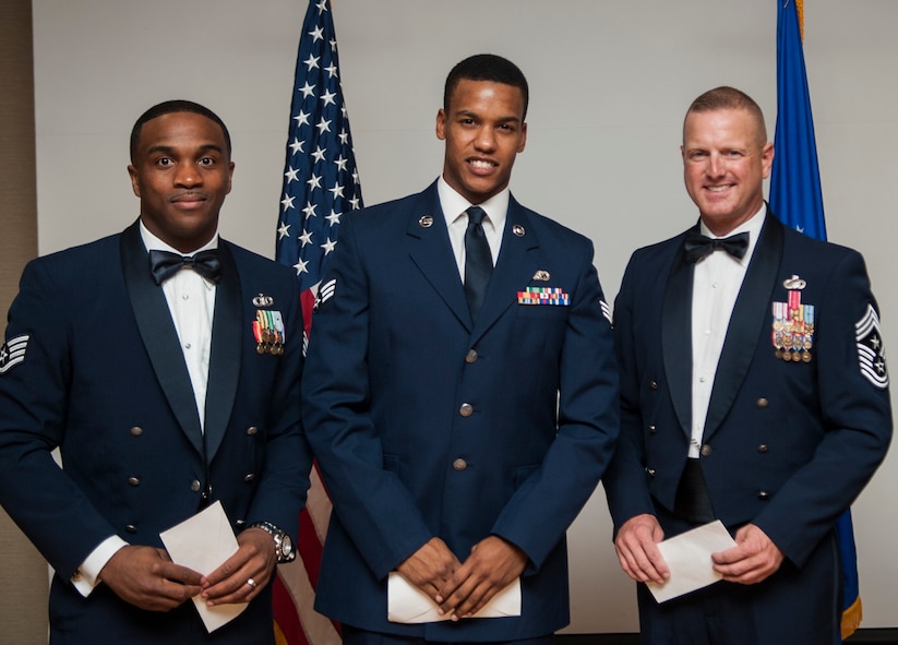 U.S. Air Force Staff Sgt. Albert Whidby, 23d Operations Support Squadron air traffic control systems specialist (left), U.S.  Air Force Senior Airman Dominique Castillo, 23d Force Support Squadron food services specialist (center) and Chief Master Sgt. Michael Goetz, 93d Air Ground Operations Wing command chief, pose for a photo at a senior NCO induction ceremony at Moody Air Force Base, Ga. July 26, 2013. As guest speakers, they represented each tier of the enlisted force at the event by giving their views on what makes a good senior NCO. (U.S. Air Force photo by Airman 1st Class Sandra Marrero/released)

