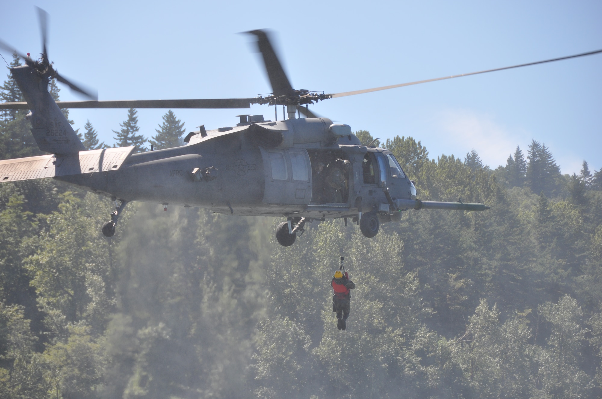 Pararescuemen from the 304th Rescue Squadron, Portland International Airport, Ore., aboard an HH-60G Pave Hawk helicopter from the 943rd Rescue Group, Davis-Monthan Air Force Base, Ariz., practice water rescue operations in the Columbia River, near Rooster Rock State Park, Ore., July 27, 2013. (U.S. Air Force Photo/Staff Sgt. N. Daniel Delgado)