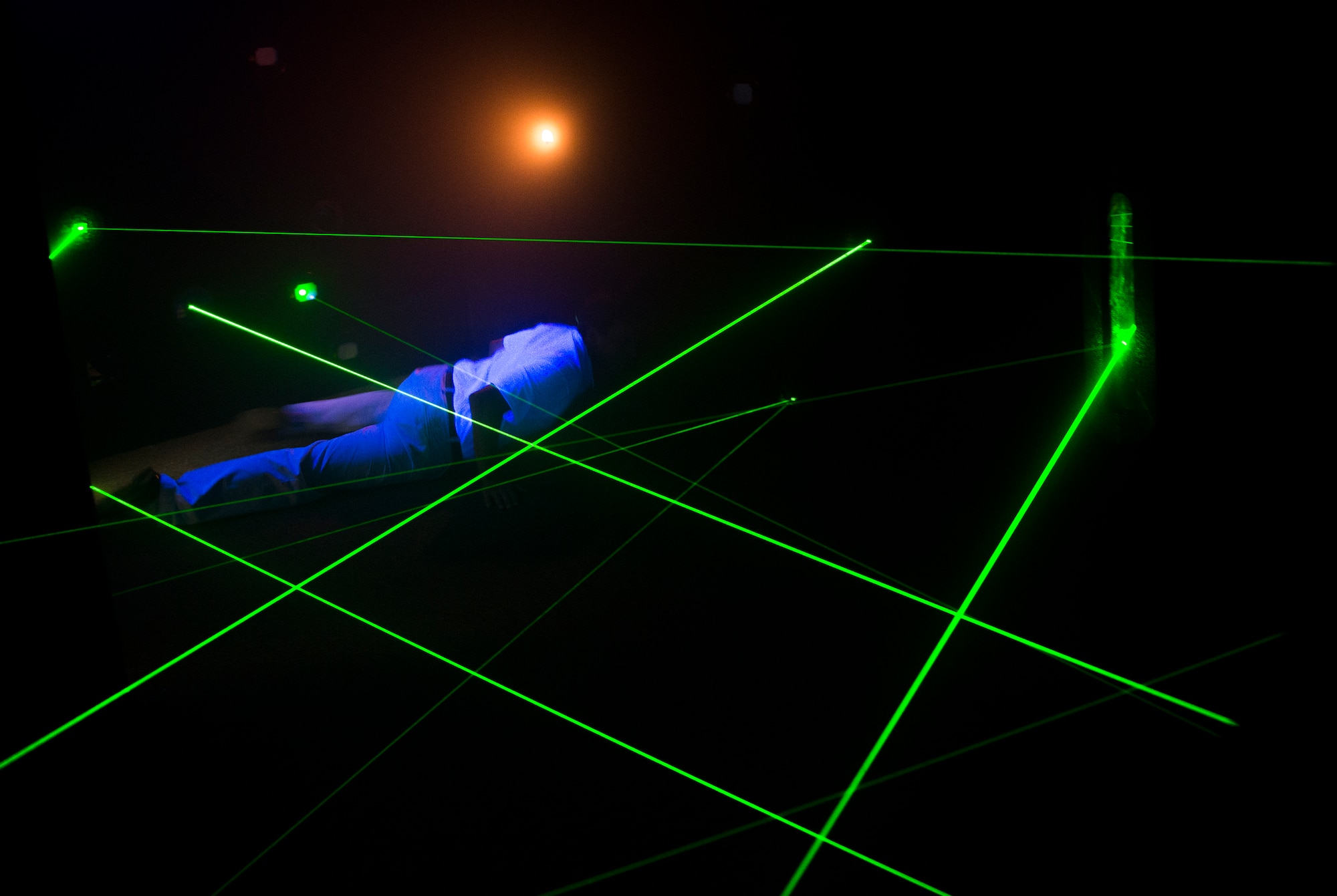 Giuseppe Pistelli, 71st Rescue Squadron honorary commander, attempts The Vault Laser Maze Challenge while touring the Spot community center during immersion day at Moody Air Force Base, Ga., July 26, 2013. During immersion day, honorary commanders toured multiple facilities from the 23d Mission Support Group and the 23d Medical Group. (U.S. Air Force photo by Senior Airman Douglas Ellis/Released)
