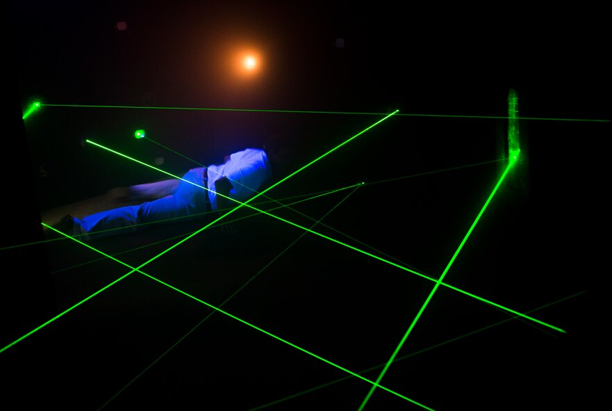 Giuseppe Pistelli, 71st Rescue Squadron honorary commander, attempts The Vault Laser Maze Challenge while touring the Spot community center during immersion day at Moody Air Force Base, Ga., July 26, 2013. During immersion day, honorary commanders toured multiple facilities from the 23d Mission Support Group and the 23d Medical Group. (U.S. Air Force photo by Senior Airman Douglas Ellis/Released)
