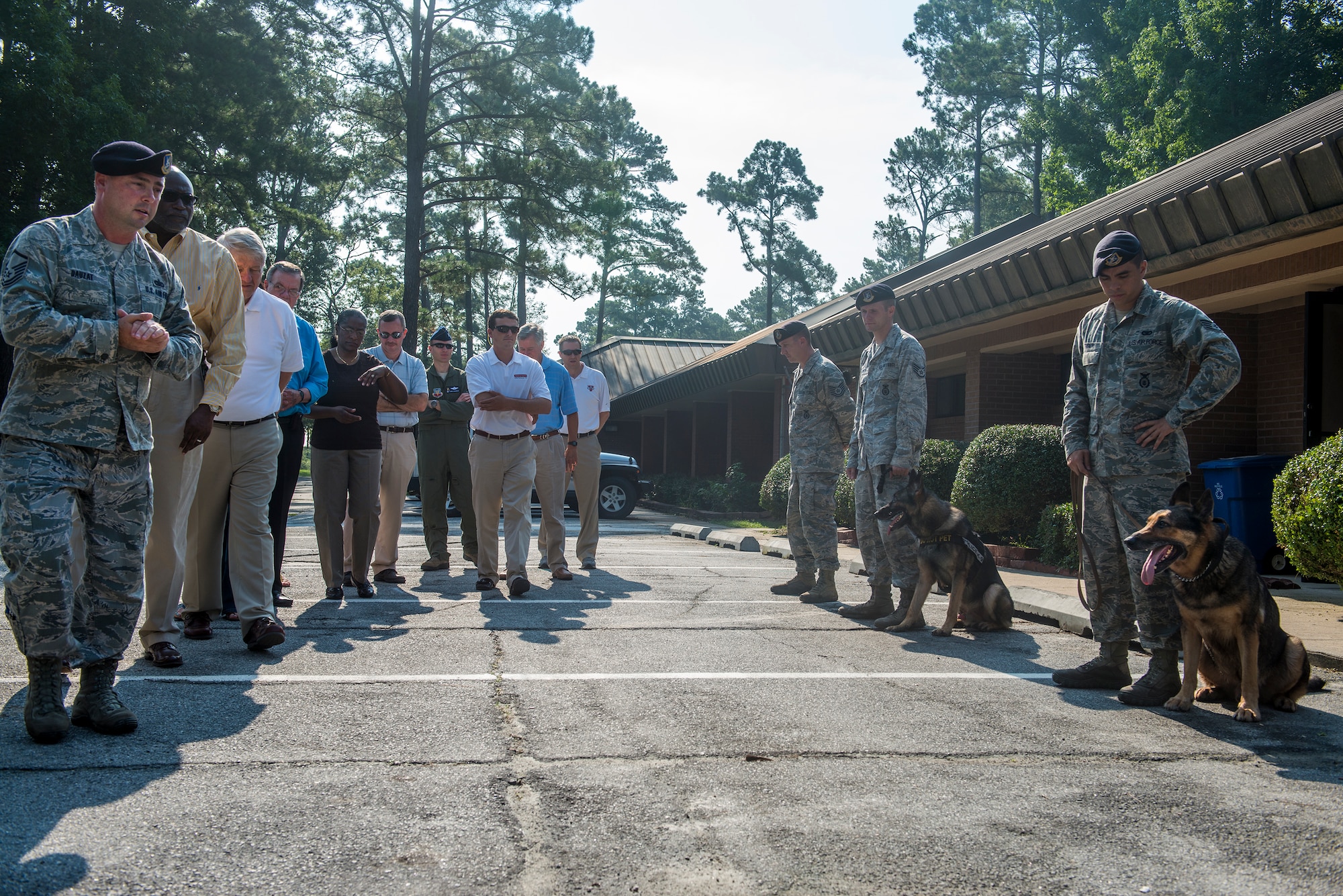 U.S. Air Force Randy Dauzat, 23d Security Forces Squadron kennel master, introduces 23d SFS military working dog handlers to honorary commanders during immersion day at Moody Air Force Base, Ga., July 26, 2013. Afterward, the handlers demonstrated the obedience and discipline of the MWDs. (U.S. Air Force photo by Senior Airman Douglas Ellis/Released)
