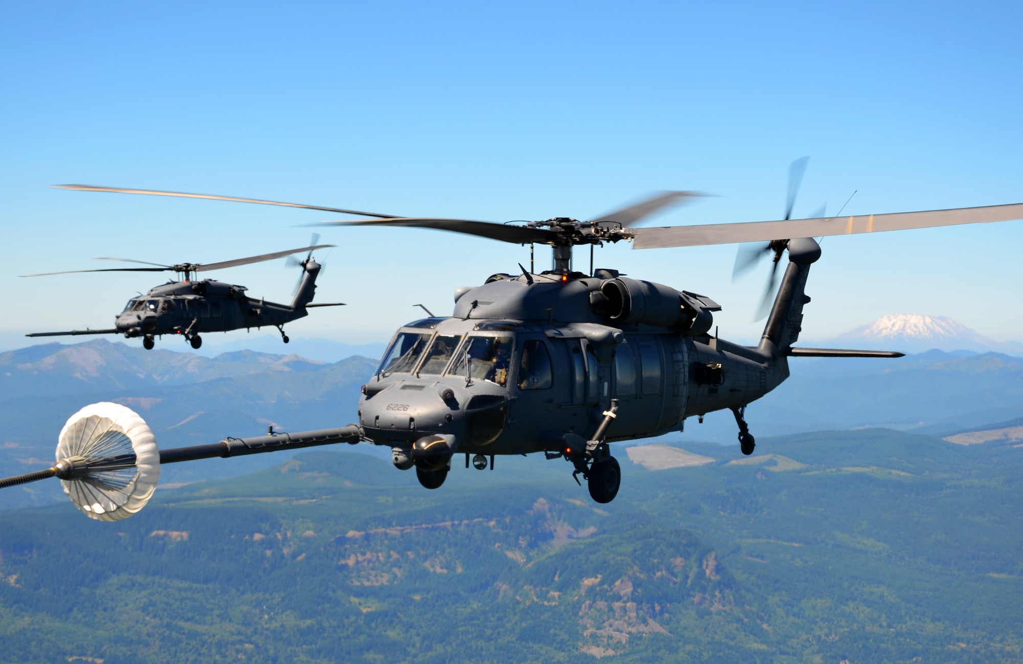 PORTLAND, Ore. -- An HH-60G Pave Hawk helicopter from the 943rd Rescue Group, Davis-Monthan Air Force Base, Ariz., refuels from an HC-130 P/N King aircraft from the 920th Rescue Wing, Patrick Air Force Base, Fla., over Portland, July 27, 2013. The refueling was part of a wing-wide training exercise among the 920th Rescue Wing’s geographically separated units from Portland, Tucson, Ariz., and Cocoa Beach, Fla. (U.S. Air Force photo/Tech. Sgt. Anna-Marie Wyant)