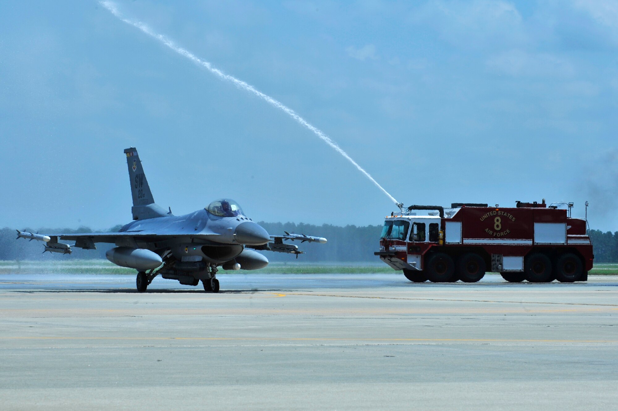 U.S. Air Force Col. Shaun McGrath, outgoing 20th Operations Group commander, passes under water from a fire truck after his final flight at Shaw Air Force Base SC., July 25, 2013.  McGrath, 20th OG commander for 16 months ,will take commander of an Expeditionary Operations Group at an undisclosed location.   (U.S. Air Force photo by Airman 1st Class Jensen Stidham/Released)