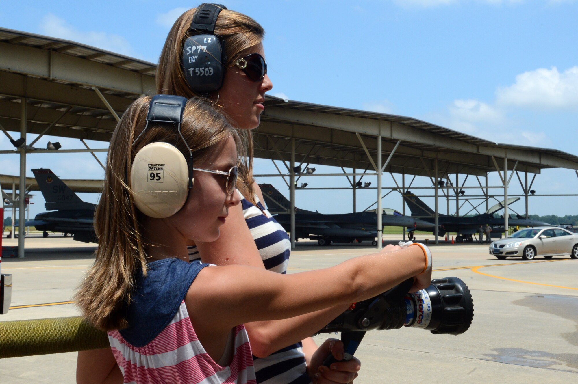 Daughters of outgoing 20th Operations Group commander U.S. Air Force Col. Shaun McGrath prepare to hose him down after his final flight, Shaw Air Force Base, S.C., July 25,  2013. McGrath will take command of an Expeditionary Operations Group at an undisclosed location. (U.S. Air Force photo by Airman 1st Class Jonathan Bass/Released)