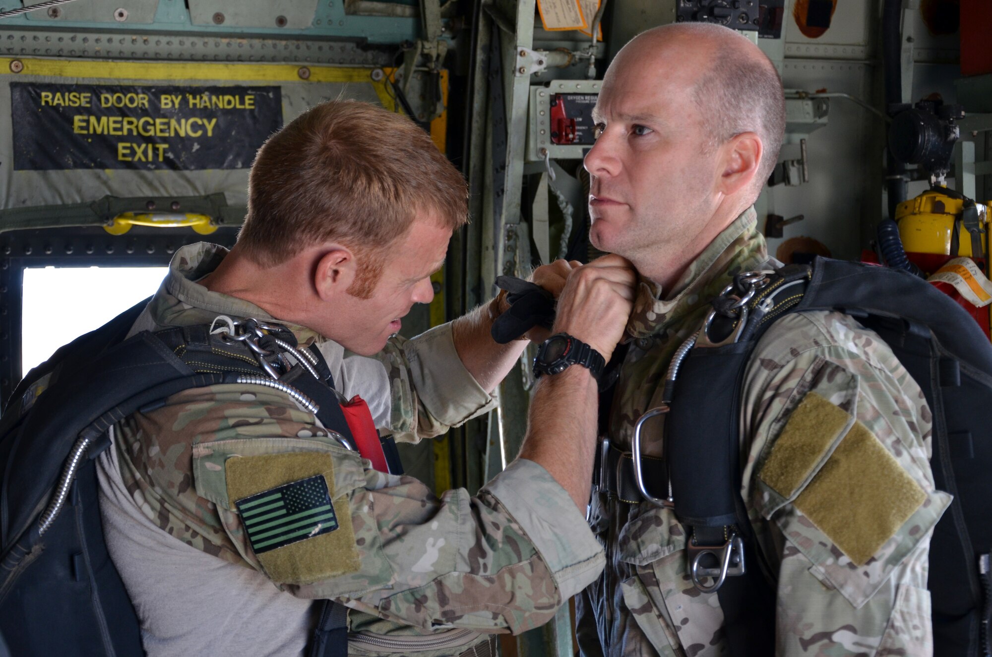 Staff Sgt. Nathan Simonson, pararescueman, 304th Rescue Squadron, Portland International Airport, Ore., inspects Master Sgt. Richard Oberstar’s jump gear aboard an HC-130 P/N King from Patrick Air Force Base, Fla., July 27, 2013. (U.S. Air Force Photo/Tech. Sgt. Anna-Marie Wyant)