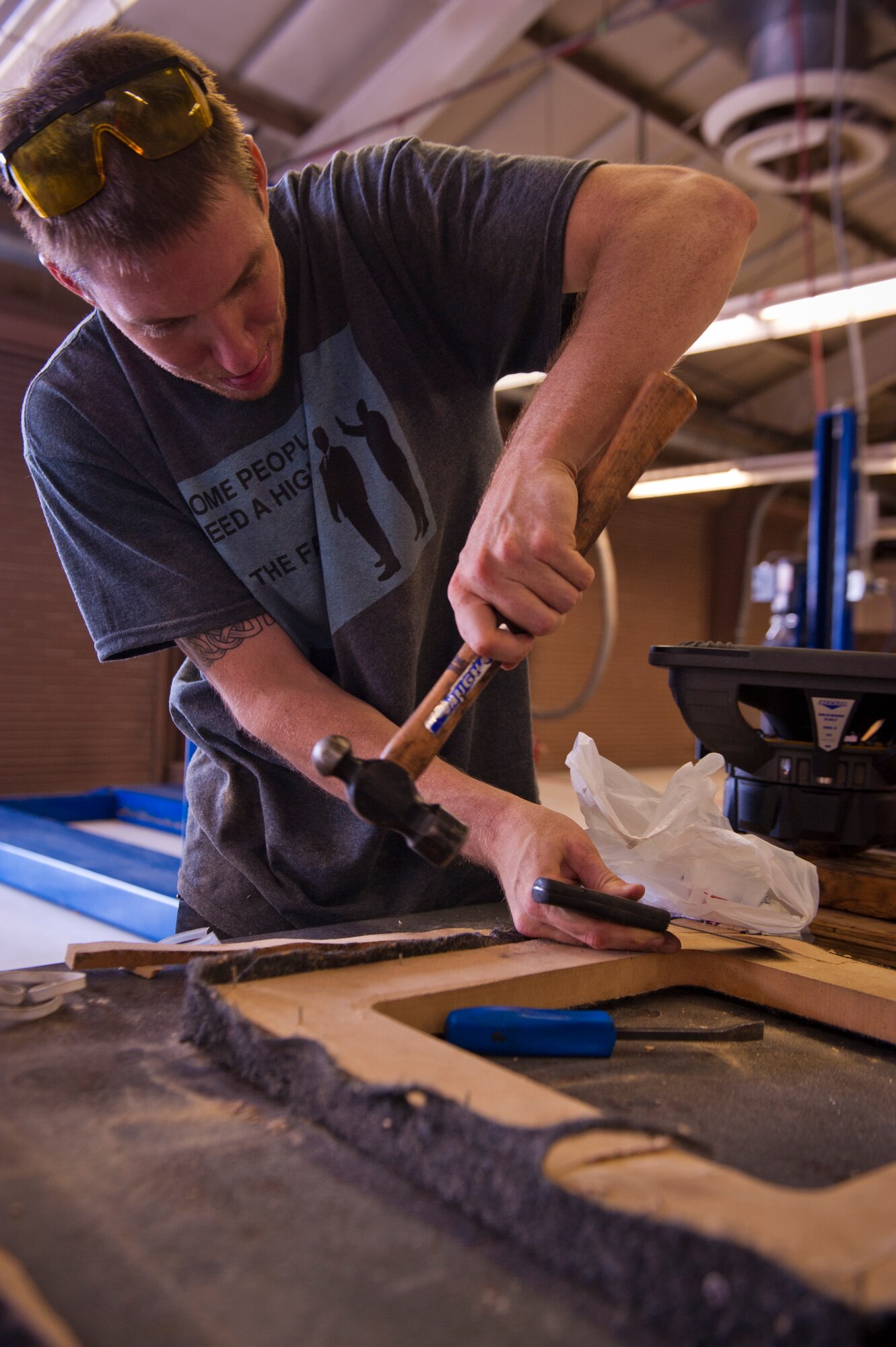 Staff Sgt. William, 6th Reconnaissance Squadron sensor operator instructor, works on a wooden speaker enclosure at the Auto Hobby Shop at Holloman Air Force Base, N.M., July 25. The Auto Hobby Shop provides a safe and professional setting where Airmen can save money by performing maintenance on their own vehicles. According to current Air Force guidance, the last name of RPA pilots and sensor operators are not releasable due to operational security constraints. (U.S. Air Force photo by Airman 1st Class Aaron Montoya/Released)