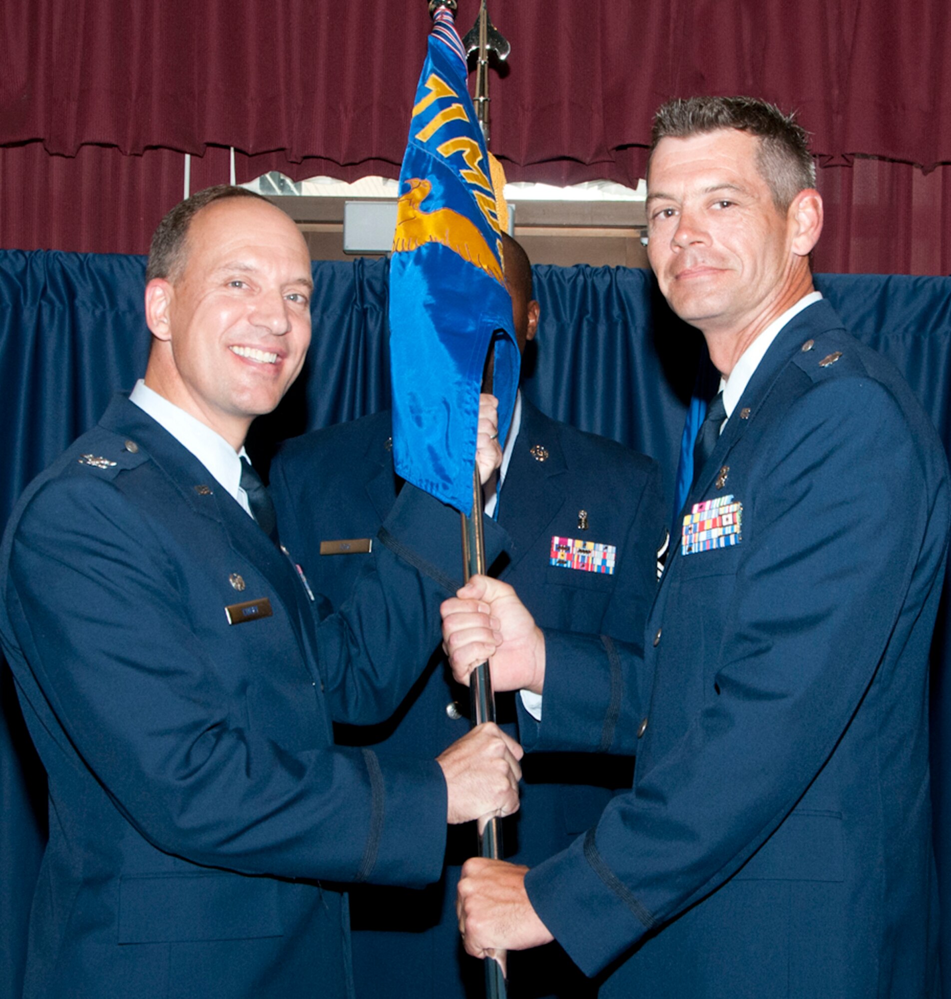 Lt. Col. Lee Erickson, right, accepts the 71st Medical Support Squadron guidon from Col. Douglas Curry, then 71st Medical Group commander, during a change of command ceremony June 18 at Vance Air Force Base, Okla. (U.S. Air Force photo/ Terry Wasson)
