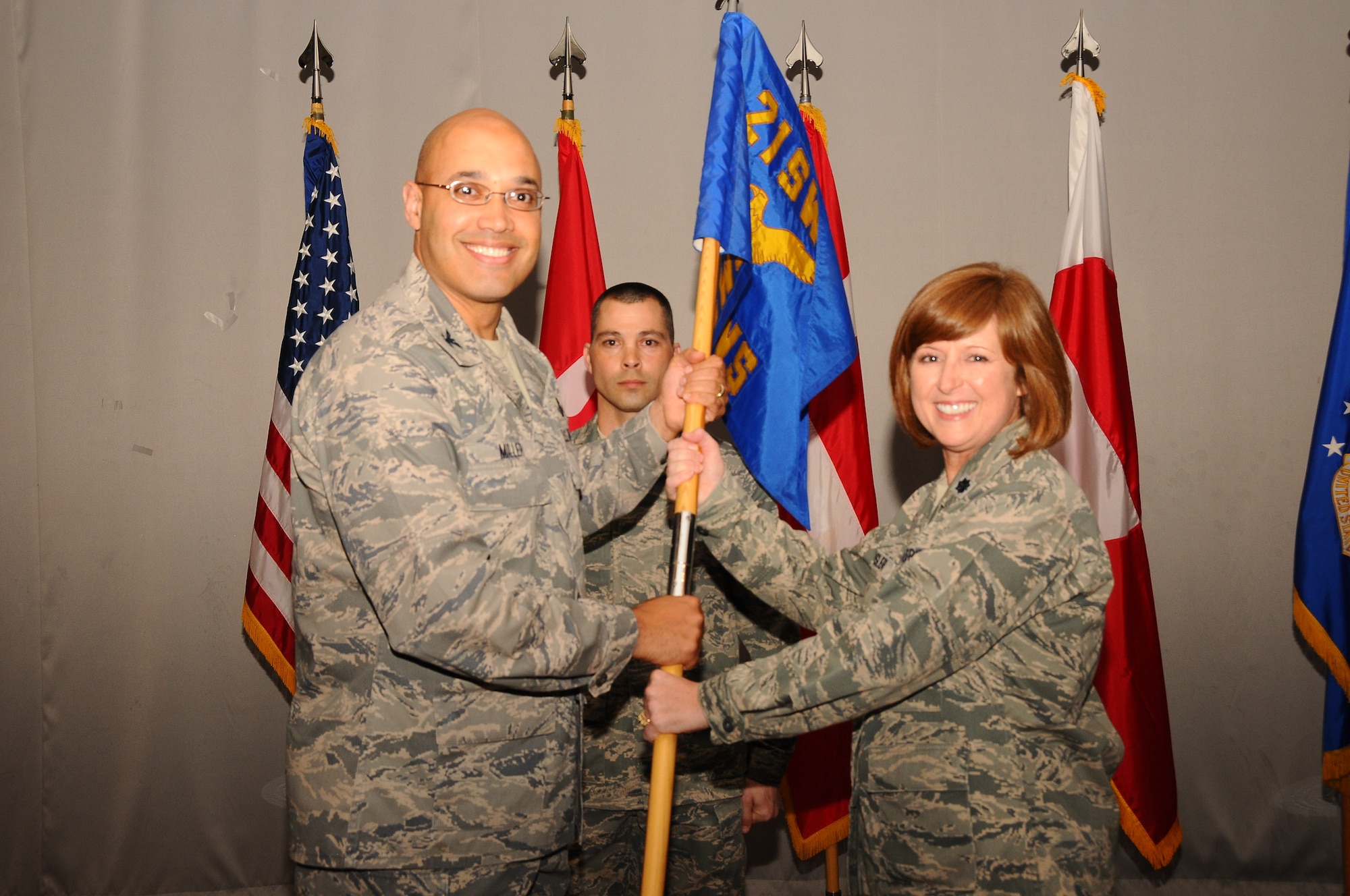 THULE AIR BASE, Greenland – Col. David Miller, 21st Operations Group commander, passes the 12th Space Warning Squadron guidon to Lt. Col. Kelly Easler during a change of command ceremony July 11. The 12th SWS is one of the 21st Space Wing’s 23 geographically separated units, and conducts continuous, real-time missile warning and missile defense vital to the security of North America, detects and tracks earth-orbiting objects in support of space situational awareness and cares for and develops disciplined and innovative Airmen. Easler replaced outgoing commander Lt. Col. Greg Karahalis. (U.S. Air Force photo)